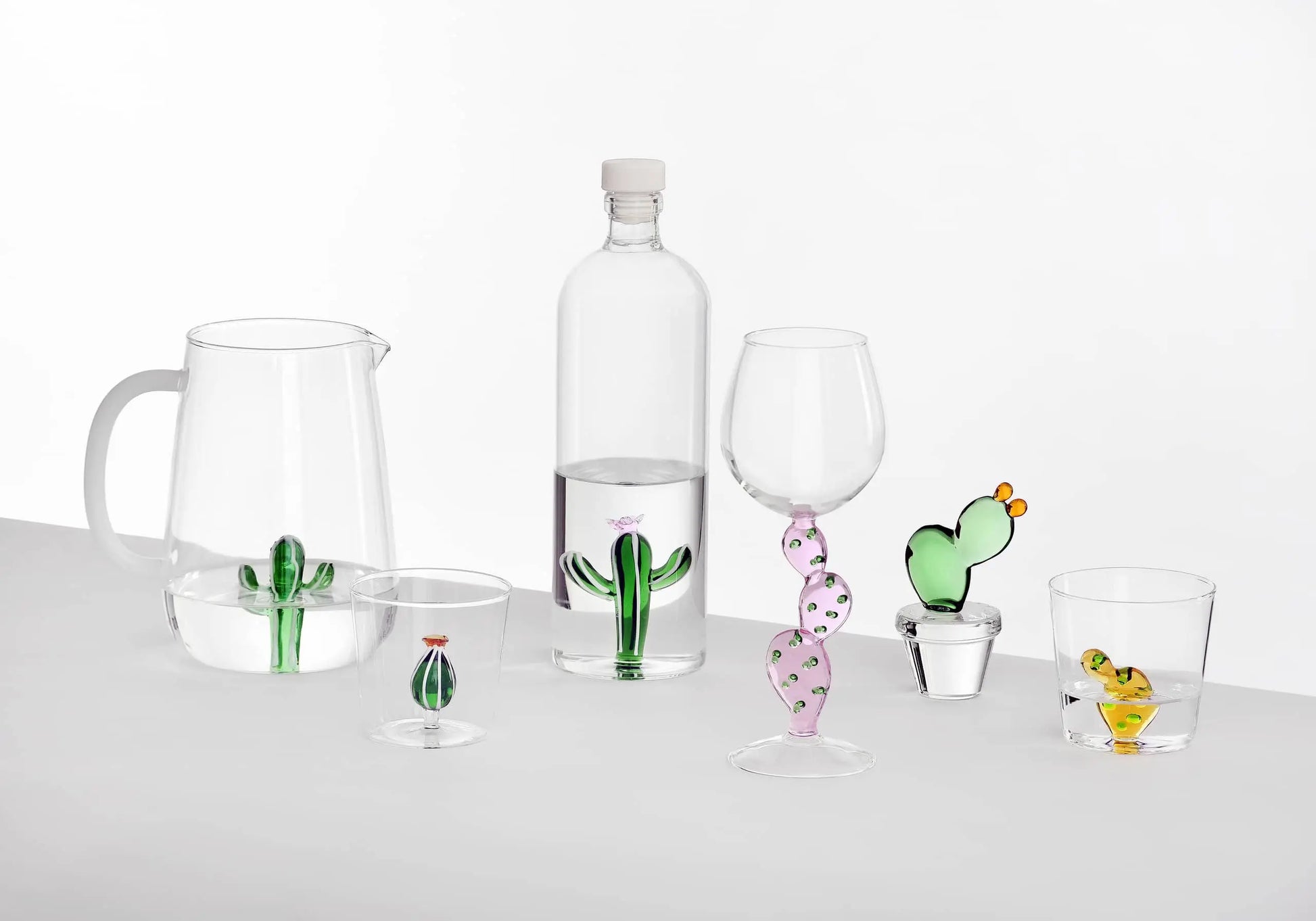 The Ichendorf Milano Desert Plants Bottle by Ichendorf Milano features delicate cactus-shaped decorations inside clear glass, bringing desert plant charm to your table.