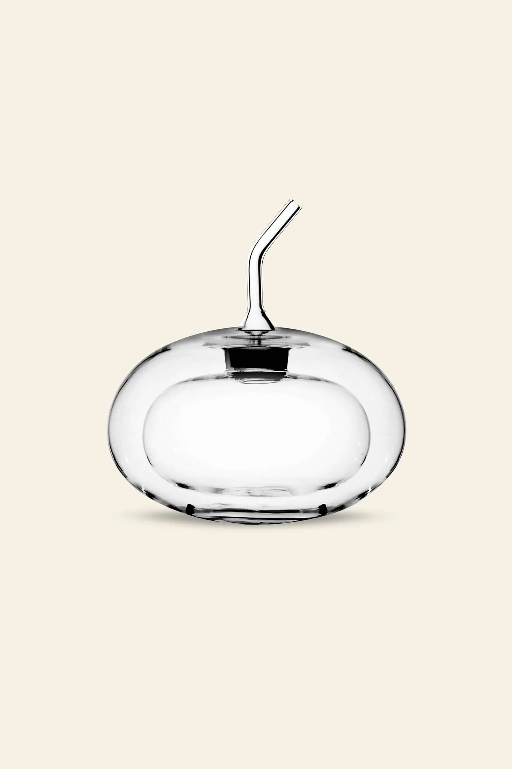 The Ichendorf Milano Sfera Doublewalled Olive Oil Bottle, designed with a clear spherical shape and short angled spout, by Ichendorf Milano, is displayed against a plain light beige background.