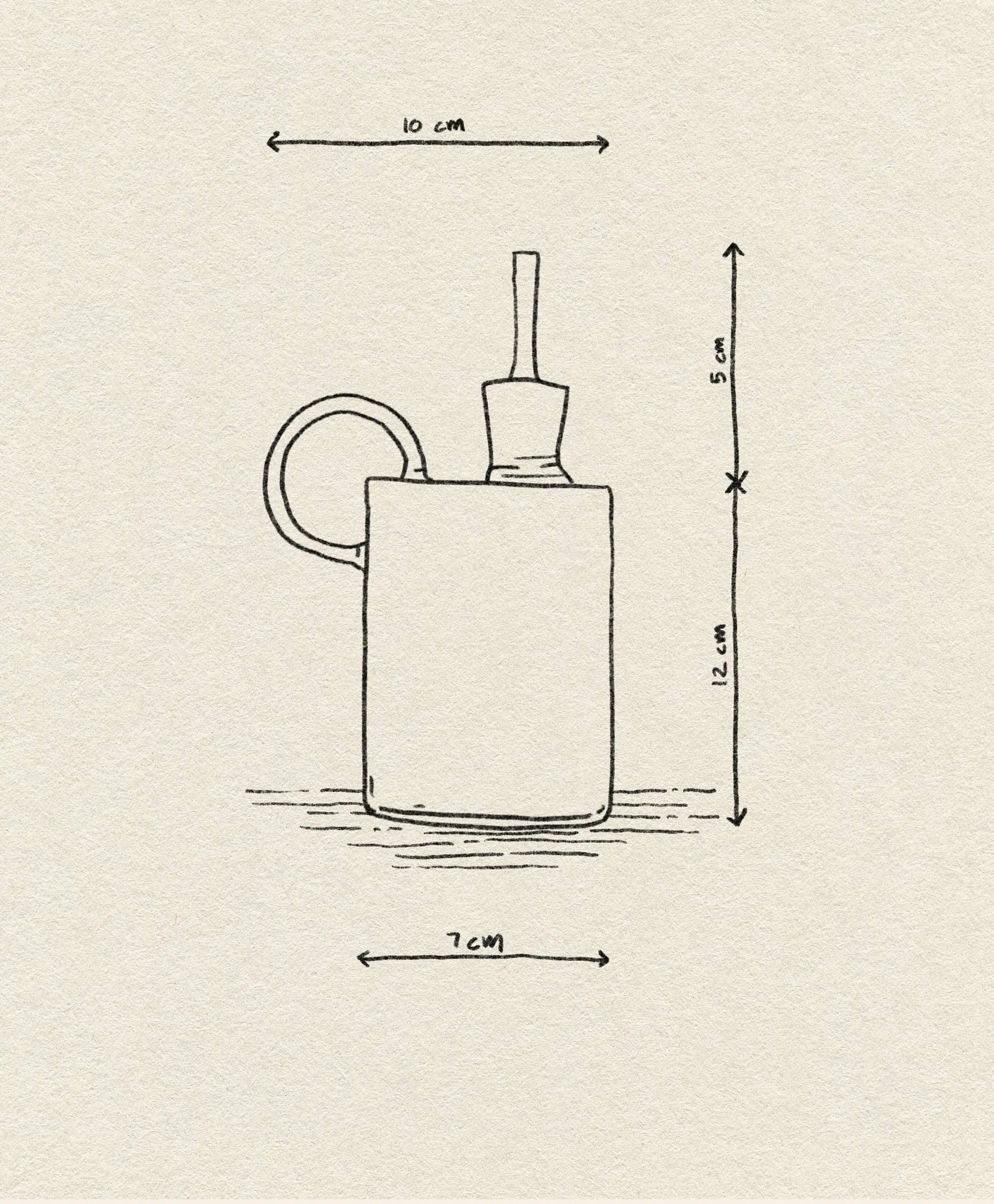A minimalist line drawing of the Ichendorf Milano Tokio Balsamic Vinegar Bottle by Ichendorf Milano features labeled dimensions: 10 cm width (with handle), 12 cm height, 5 cm for the stopper, and a base width of 7 cm.