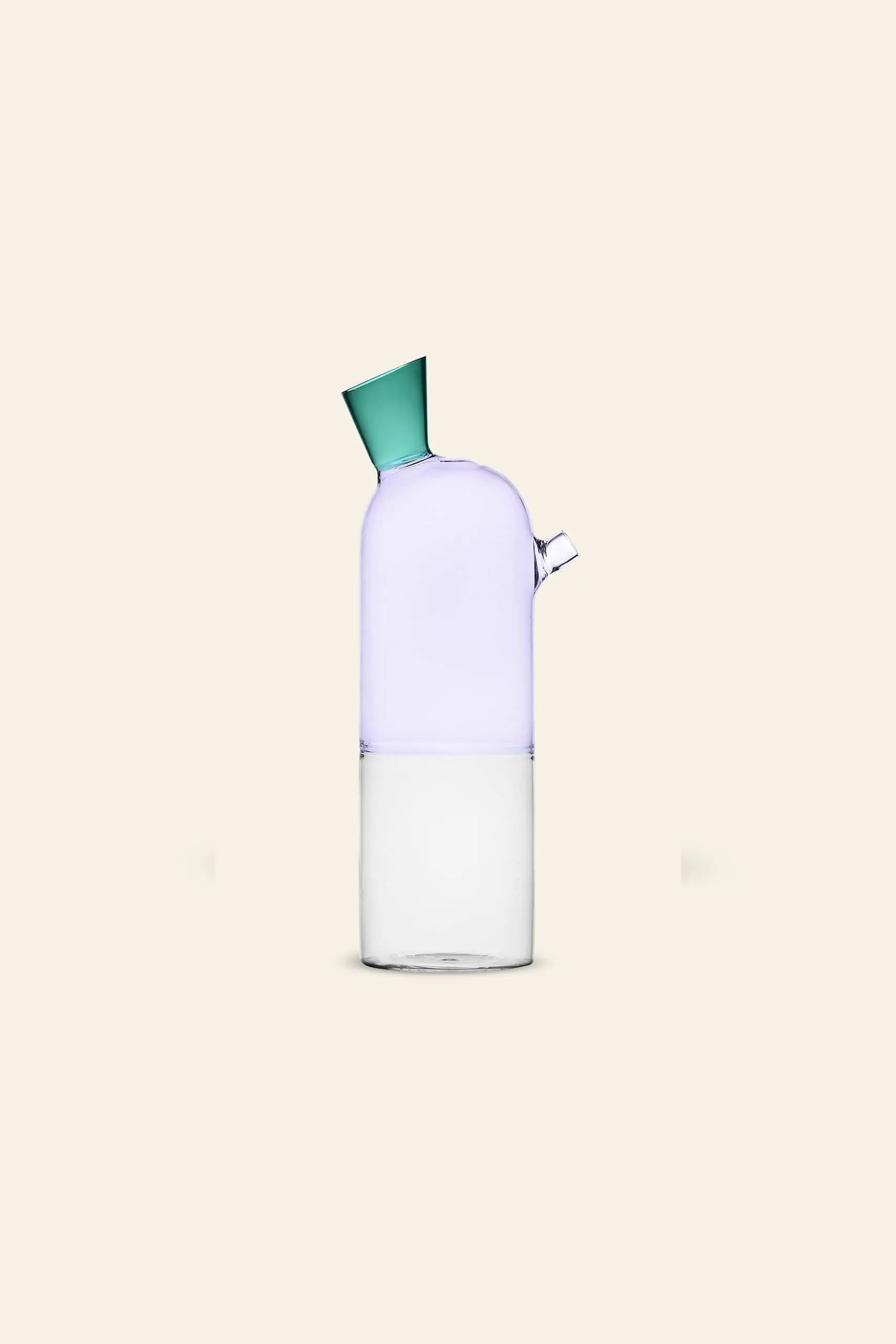 The Ichendorf Milano Travasi Bottle by Ichendorf Milano boasts a modern, minimalist look with a geometric design—purple top, green angled spout, clear base—displayed on a plain beige background.