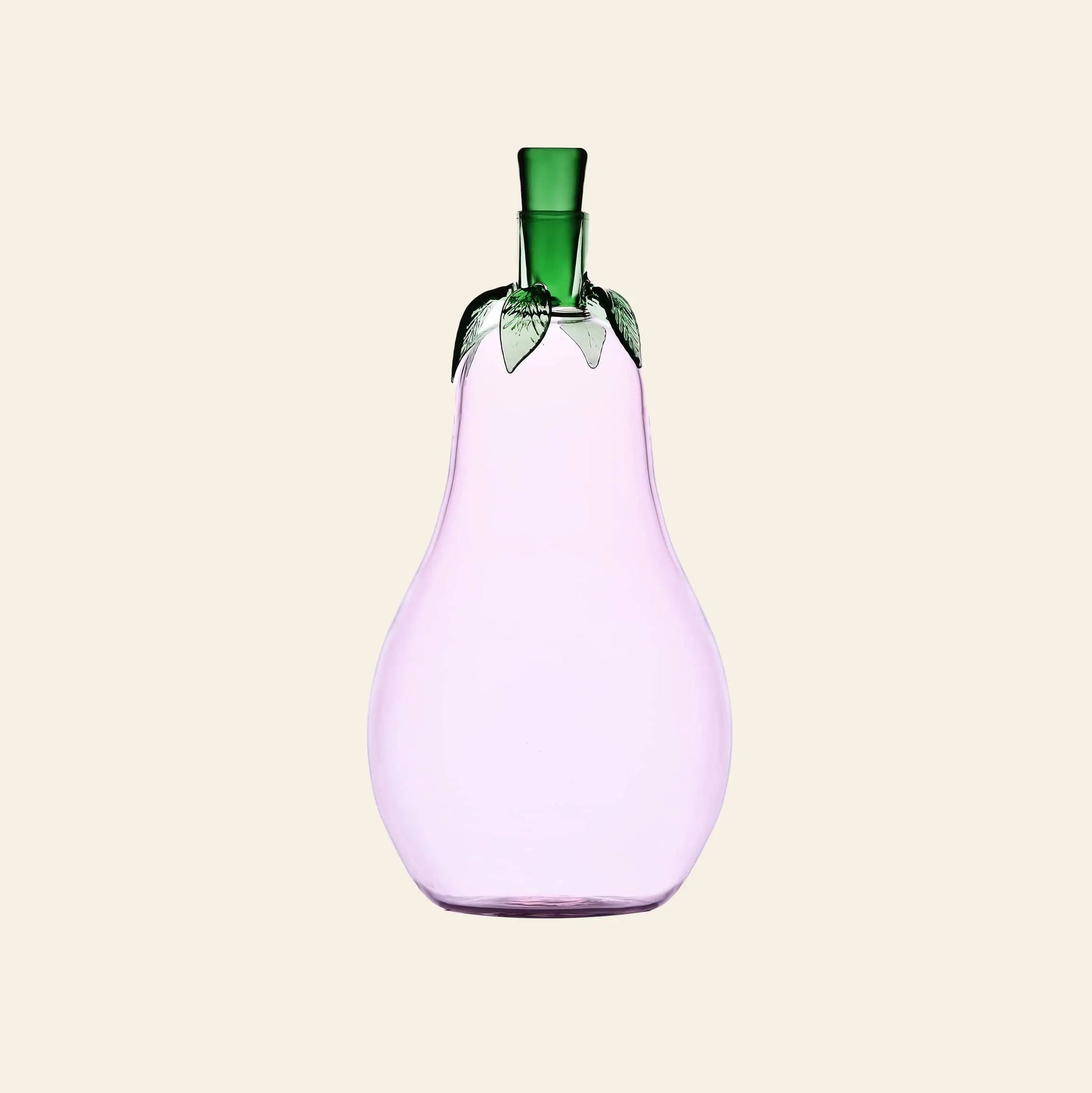 The Ichendorf Milano Vegetables Bottle by Ichendorf Milano is a handcrafted glass bottle shaped like a pear, with a light purple body and green leaf-like top, making it a charming decorative piece against a beige background.