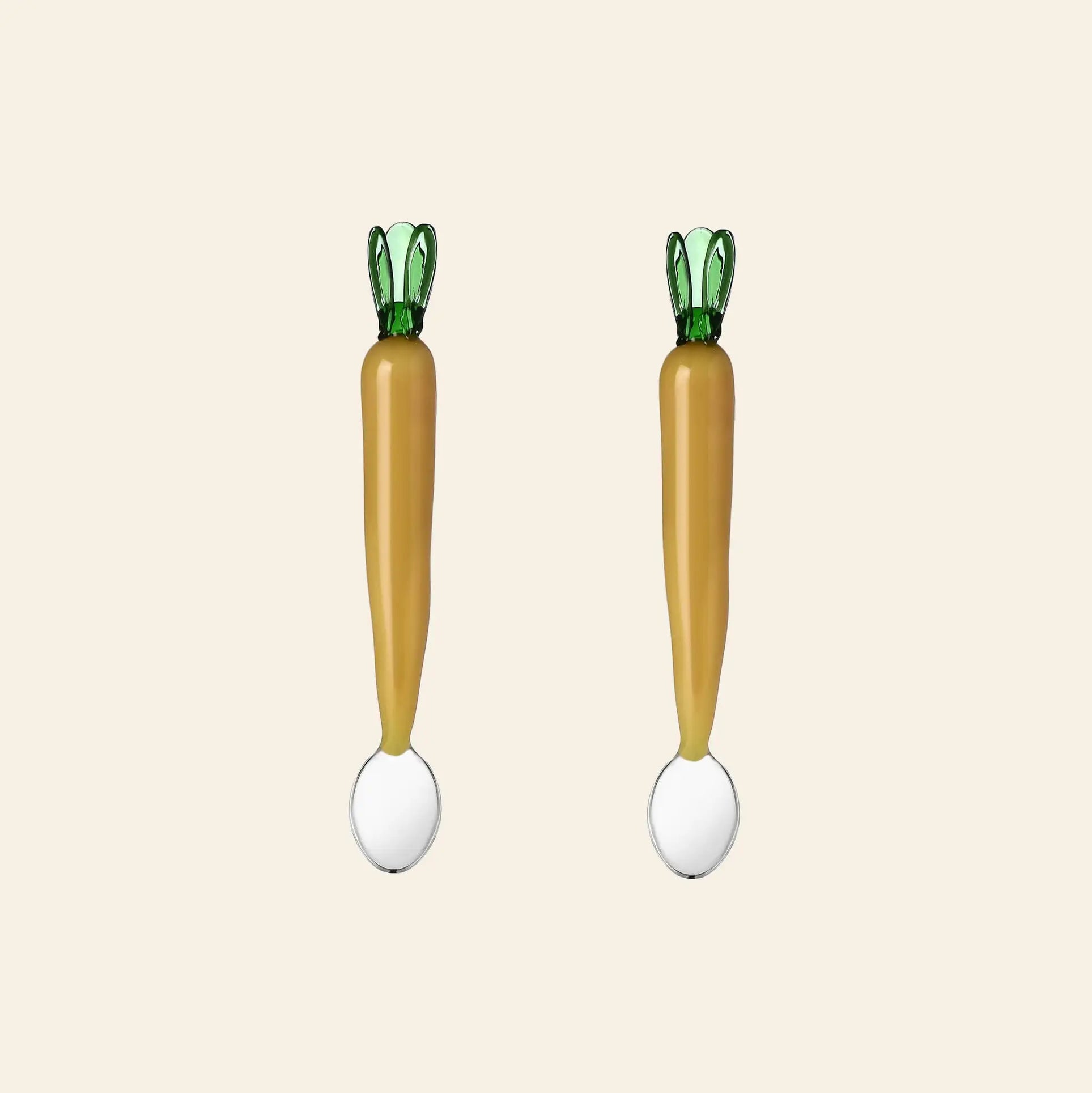 The Ichendorf Milano Vegetables Spoons, Set of 2 by Ichendorf Milano features two carrot-shaped handcrafted spoons with green tops and white scoops, displayed side by side on a plain light background.