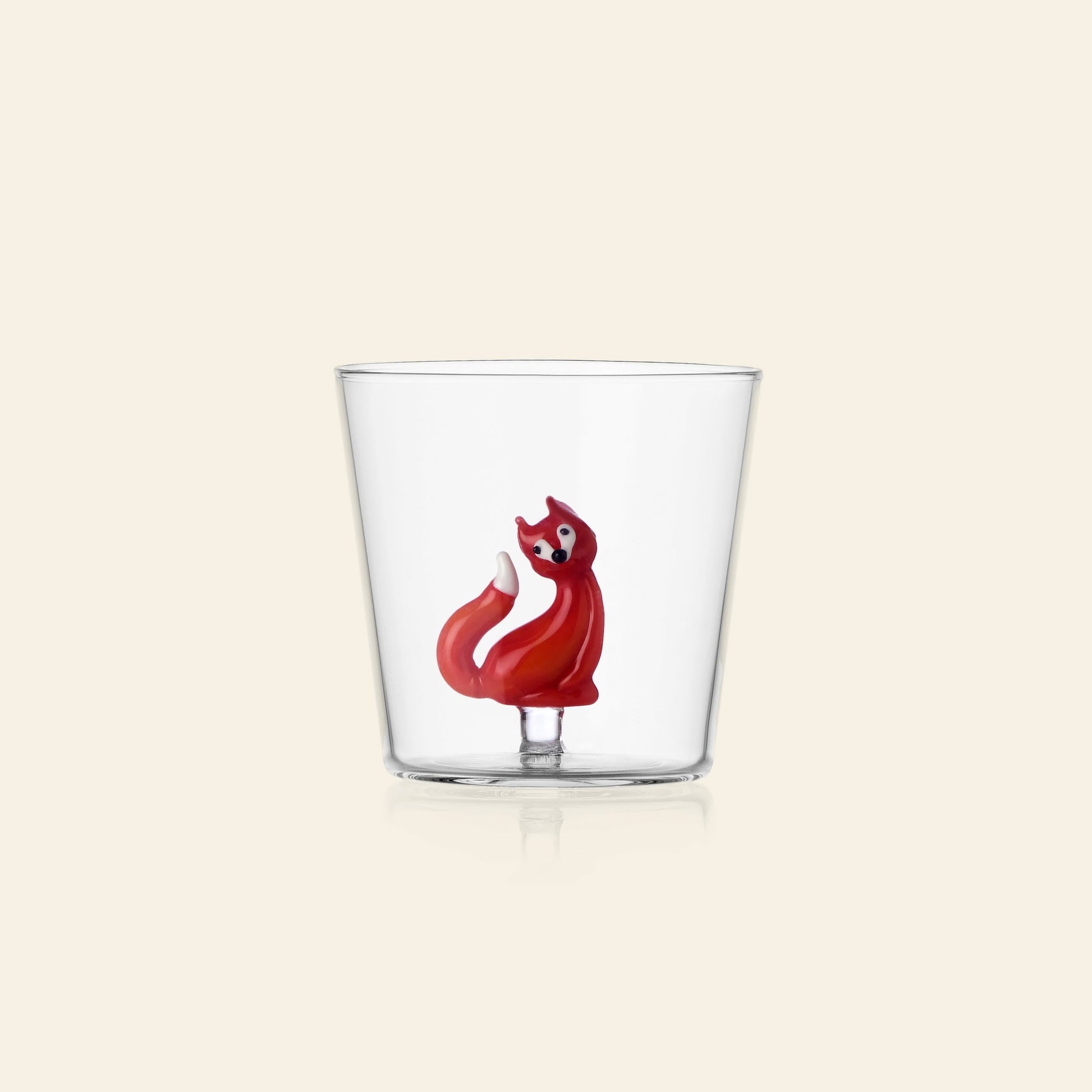 The Ichendorf Milano Woodland Tales Tumbler by Ichendorf Milano is a clear glass featuring a small red fox figurine at the base, shown against a plain cream background.