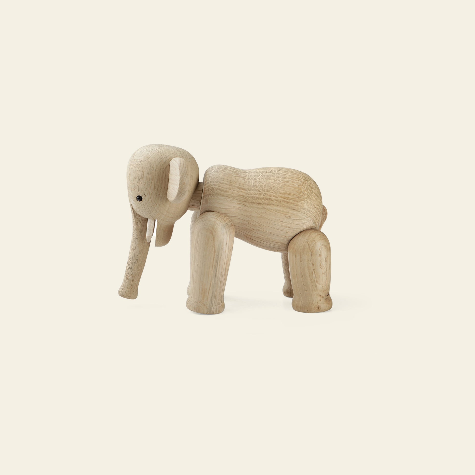 The Kay Bojesen Elephant Mini by Kay Bojesen, a Danish-designed wooden figurine with jointed legs and trunk, stands on a light background. Its smooth finish and simple features evoke the timeless charm of the classic original.
