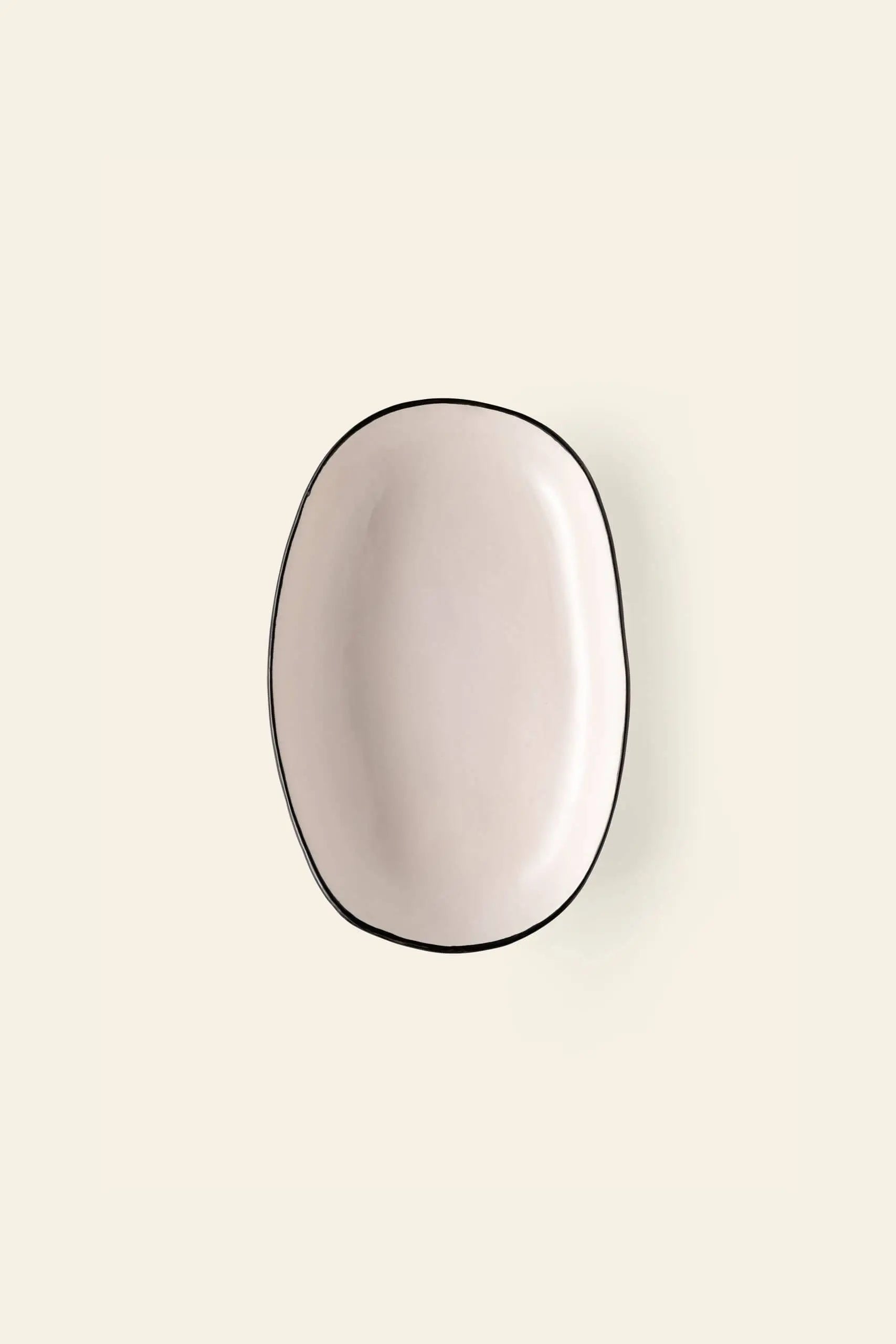 The Kra Sanctuary Andaman Family Sharing Dish by Kra Sanctuary is an off-white ceramic plate with a classic white glaze and thin black outline, bringing island-inspired elegance to your table.