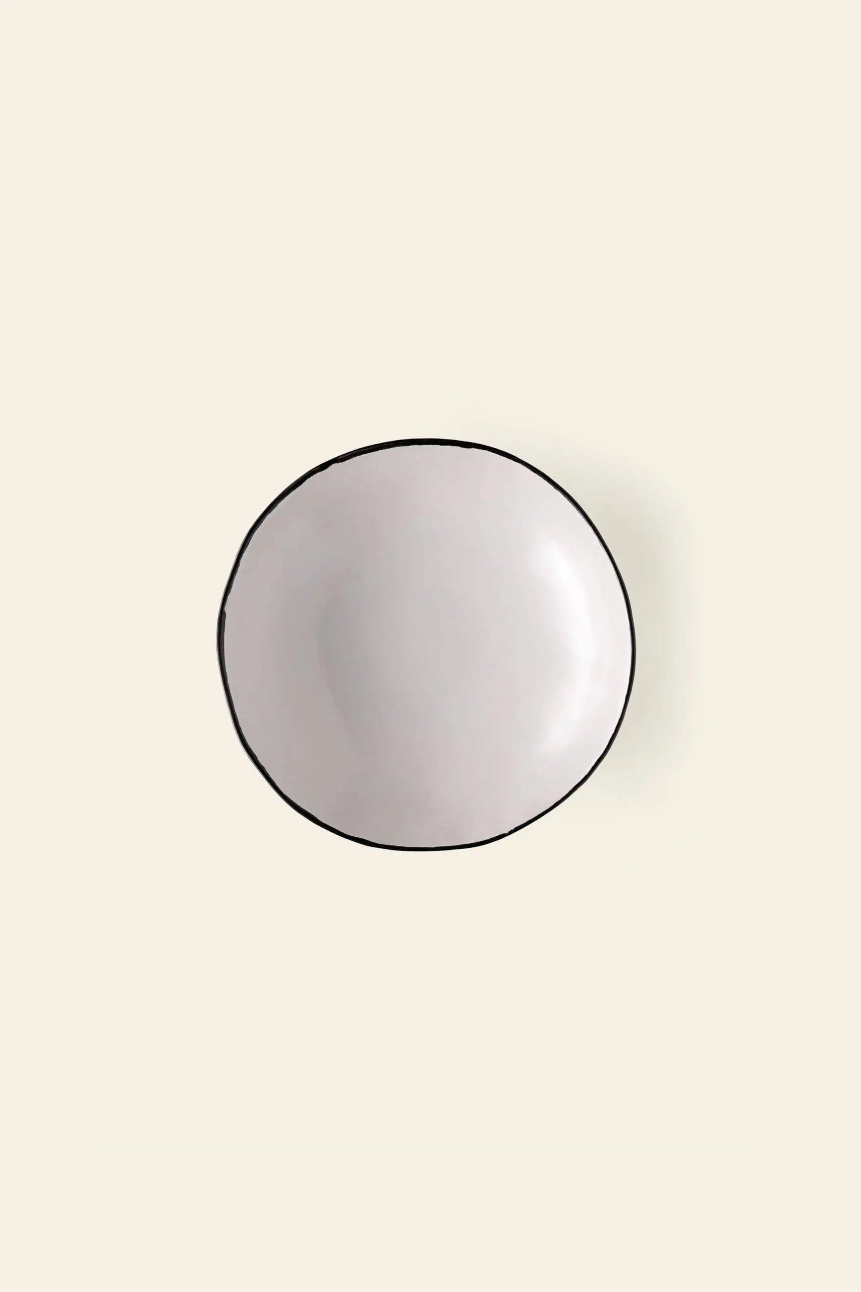 The Kra Sanctuary Andaman Free-Form Dinner Plate features a classic white glaze and timeless design, inspired by island living. Seen from above on a light beige background, it embodies the effortless elegance of Kra Sanctuary diningware.
