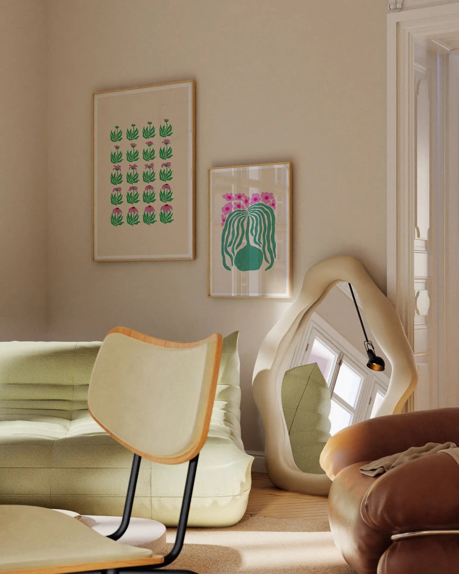 A cozy living room corner features a green sofa, modern cream chair, wavy floor mirror, and two Liv Lee Daisy Frames art prints by Liv Lee on Hahnemühle paper adorning the beige wall in soft natural light.