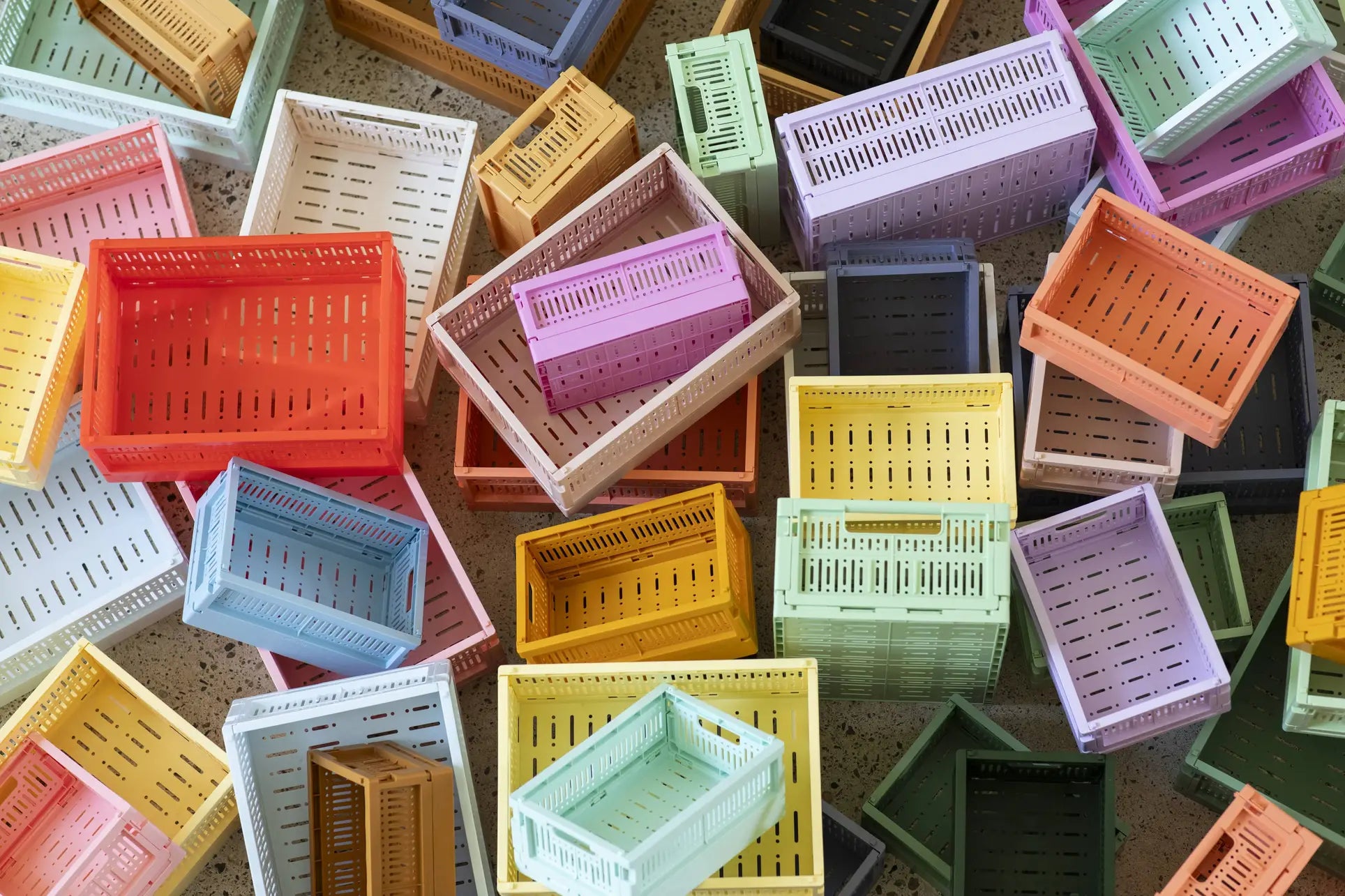 Made Crate Midi by Made Crate are colorful, eco-friendly folding crates made from recycled plastic. Available in yellow, orange, pink, blue, green, purple, and beige for vibrant style and easy stacking.