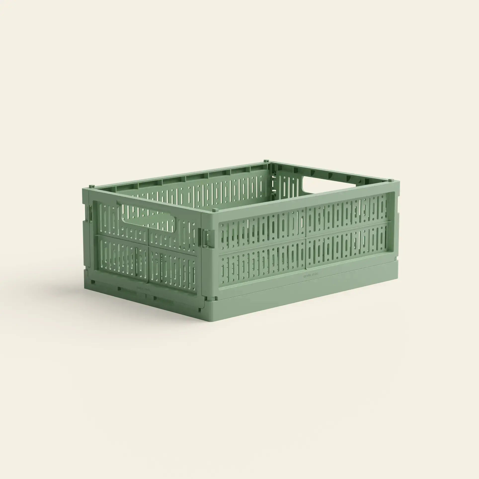 The Made Crate Midi by Made Crate is a light green, rectangular recycled plastic storage crate with side handles and a ventilated slatted design for easy stacking, shown against a plain off-white background.
