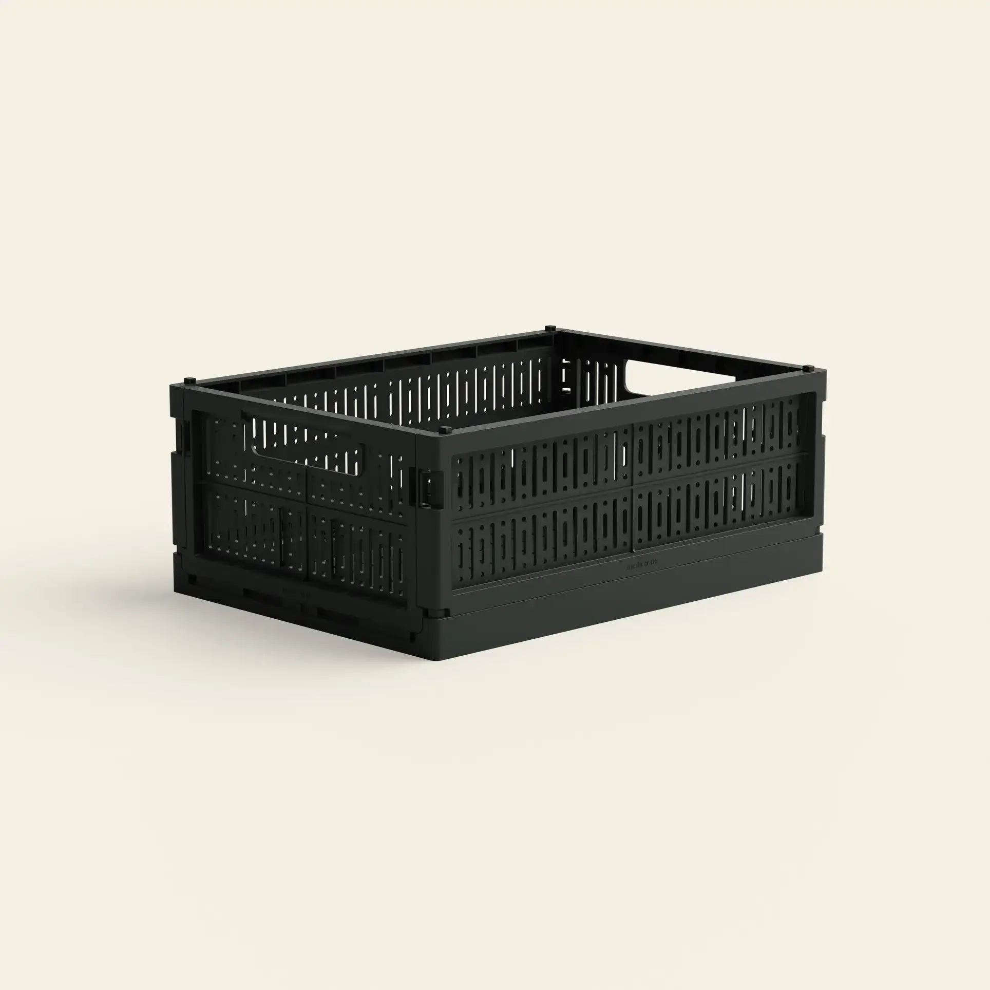 The Made Crate Midi by Made Crate is a black, rectangular storage crate with ventilated sides and built-in handles, crafted from recycled plastic for easy stacking, shown on a plain light background.
