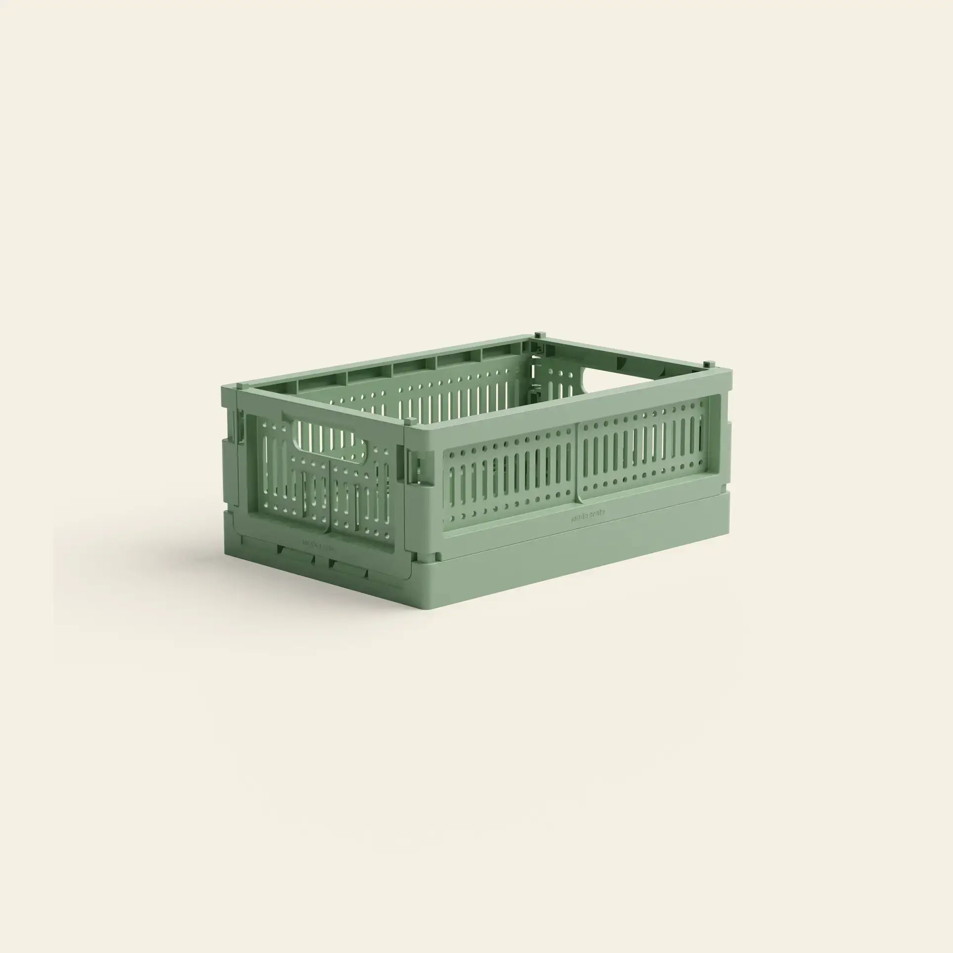 The Made Crate Mini by Made Crate is a green, stackable storage crate made from recycled plastic with ventilation holes, shown on a plain light background, offering convenient organization.