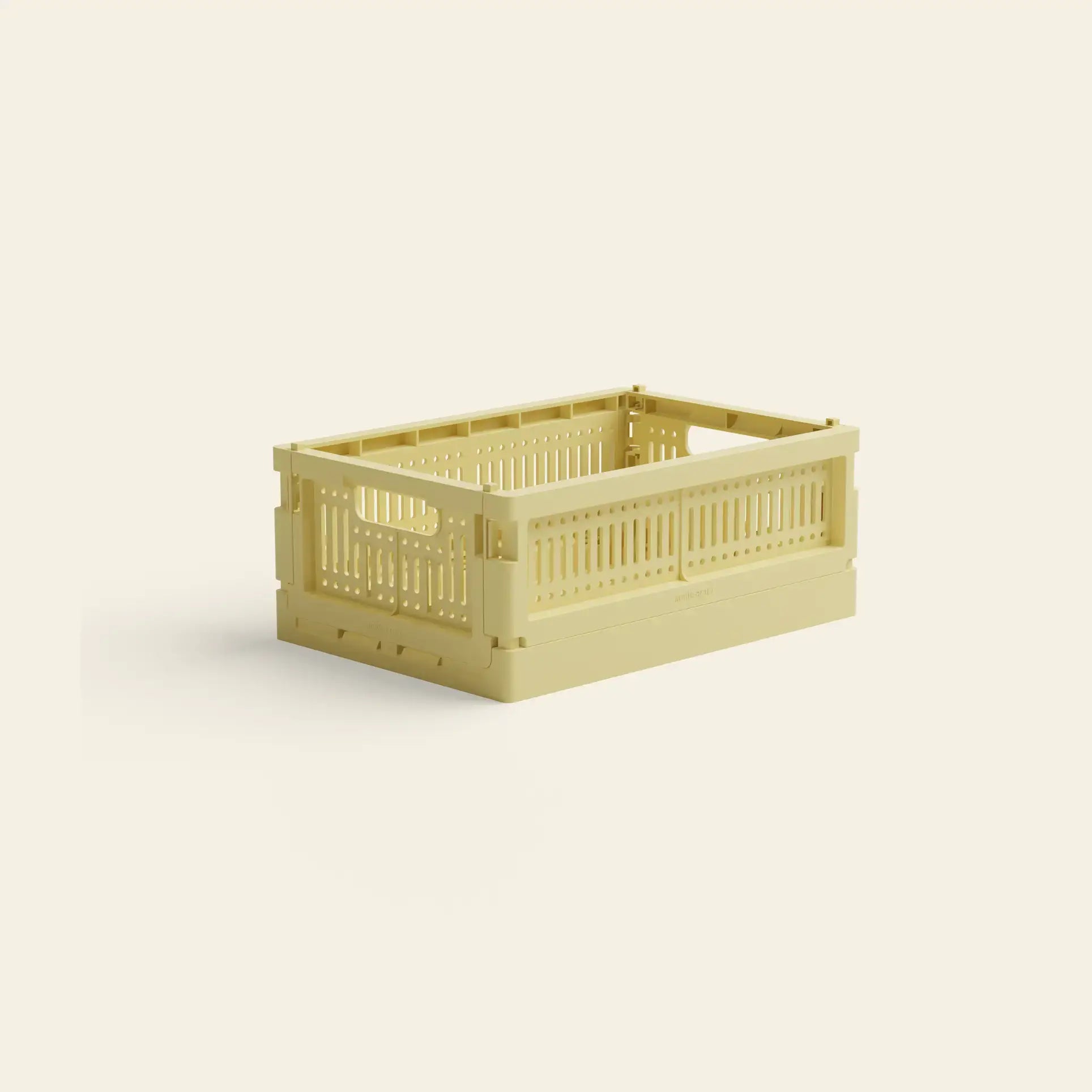 The Made Crate Mini by Made Crate is a beige, eco-friendly folding crate with open sides and handles, made from recycled plastic for stackable convenience and shown on a plain light background.