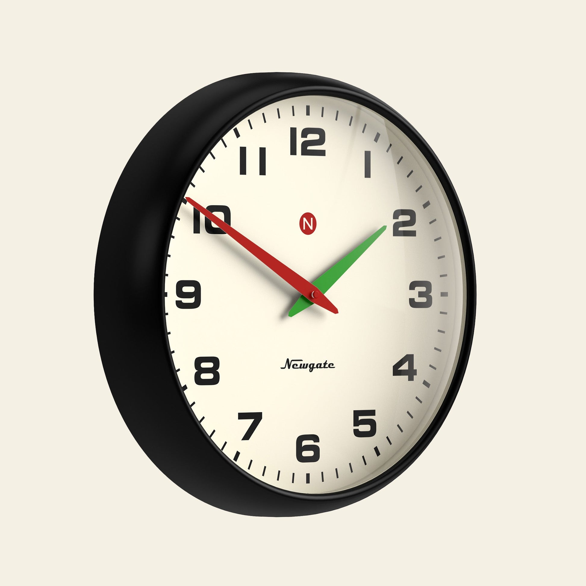 The Newgate Superstore Wall Clock by Newgate features a retro black frame, cream face, bold black numerals, and three hands: black hour at 2, green minute at 7, red second at 10—reading about 2:35:50 in vintage-inspired style.