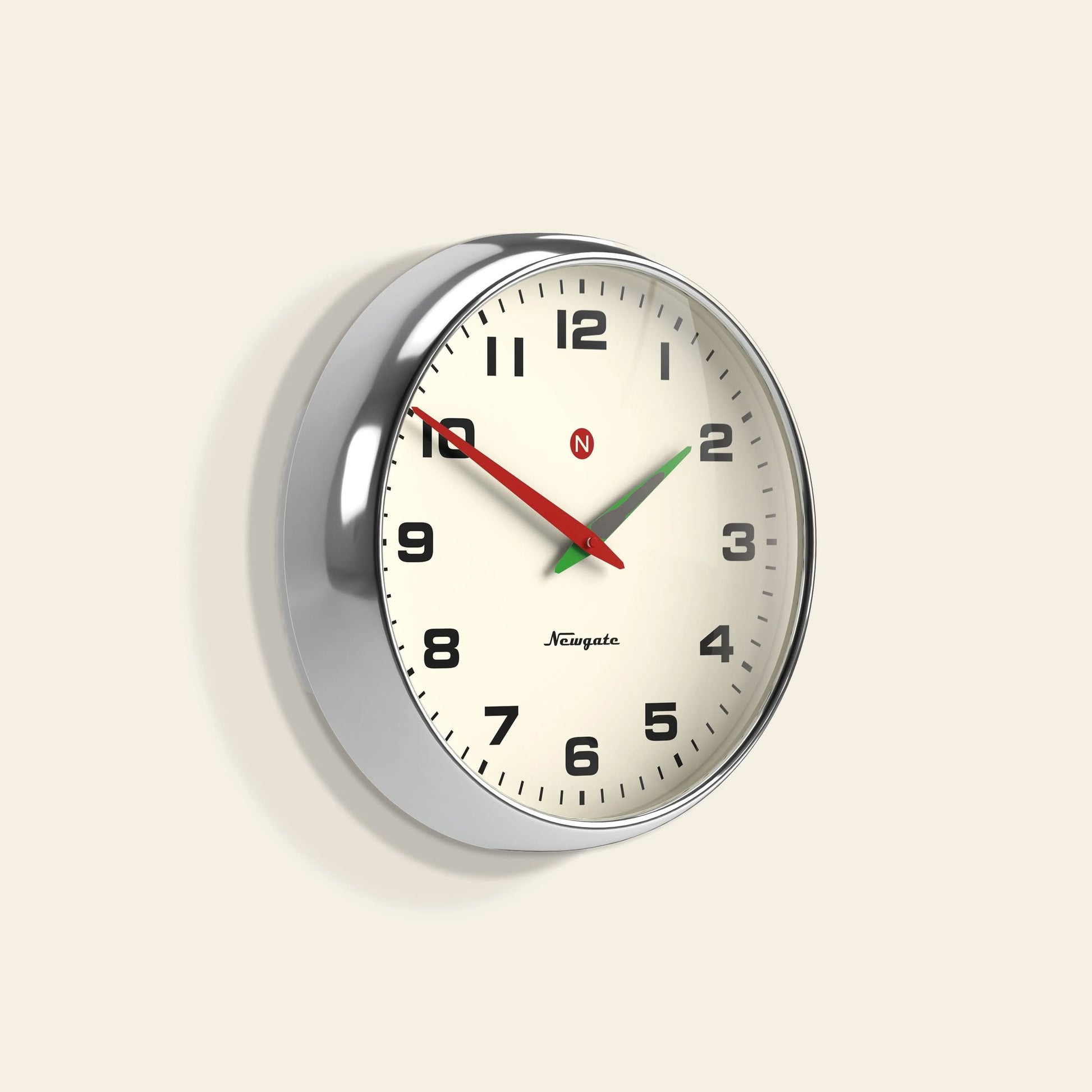 The Newgate Superstore Wall Clock features a round retro design with a cream face, black numbers, silver frame, black hour and minute hands, red second hand, and displays 10:08:37. Its vintage look is highlighted by the visible Newgate branding.