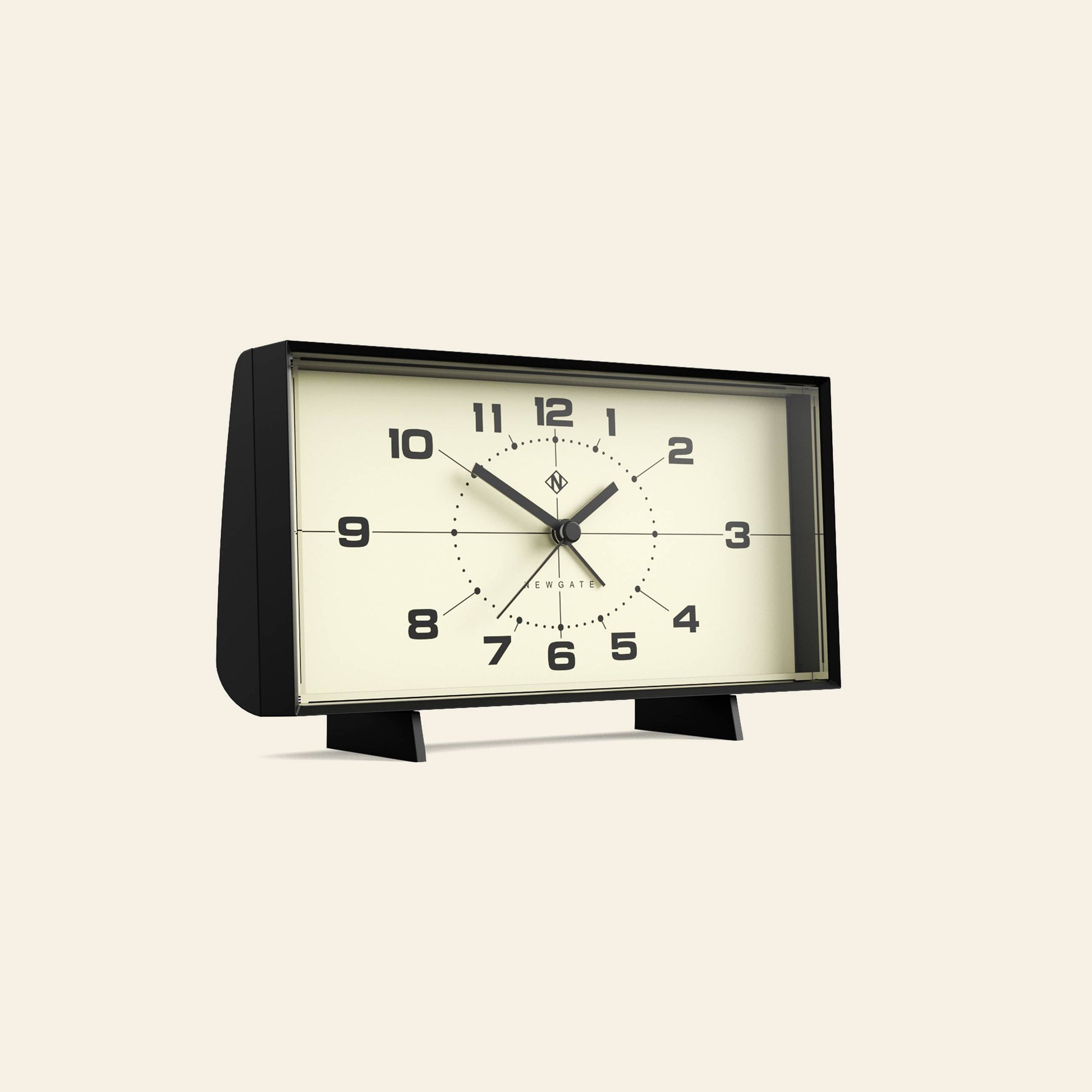 The Newgate Wideboy Alarm Clock by Newgate is a rectangular, retro-inspired clock with bold black numbers and hands on a cream face, featuring a mid-century atomic dial and two short legs, shown against a plain beige background.