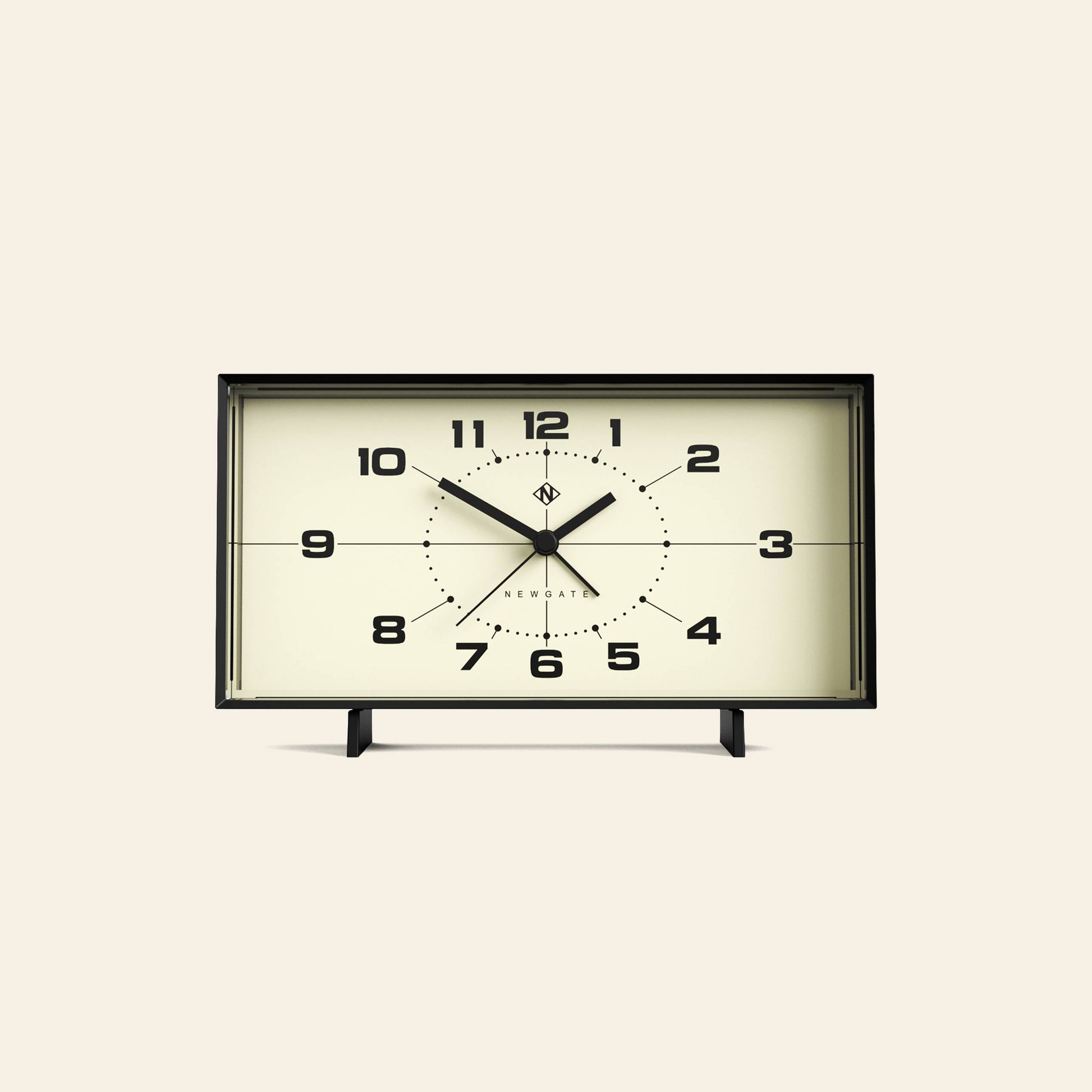 The Newgate Wideboy Alarm Clock features a rectangular retro design with a cream face, black frame and numbers, mid-century atomic dial, two small legs, and displays 10:09:37 with the Newgate brand near the center.