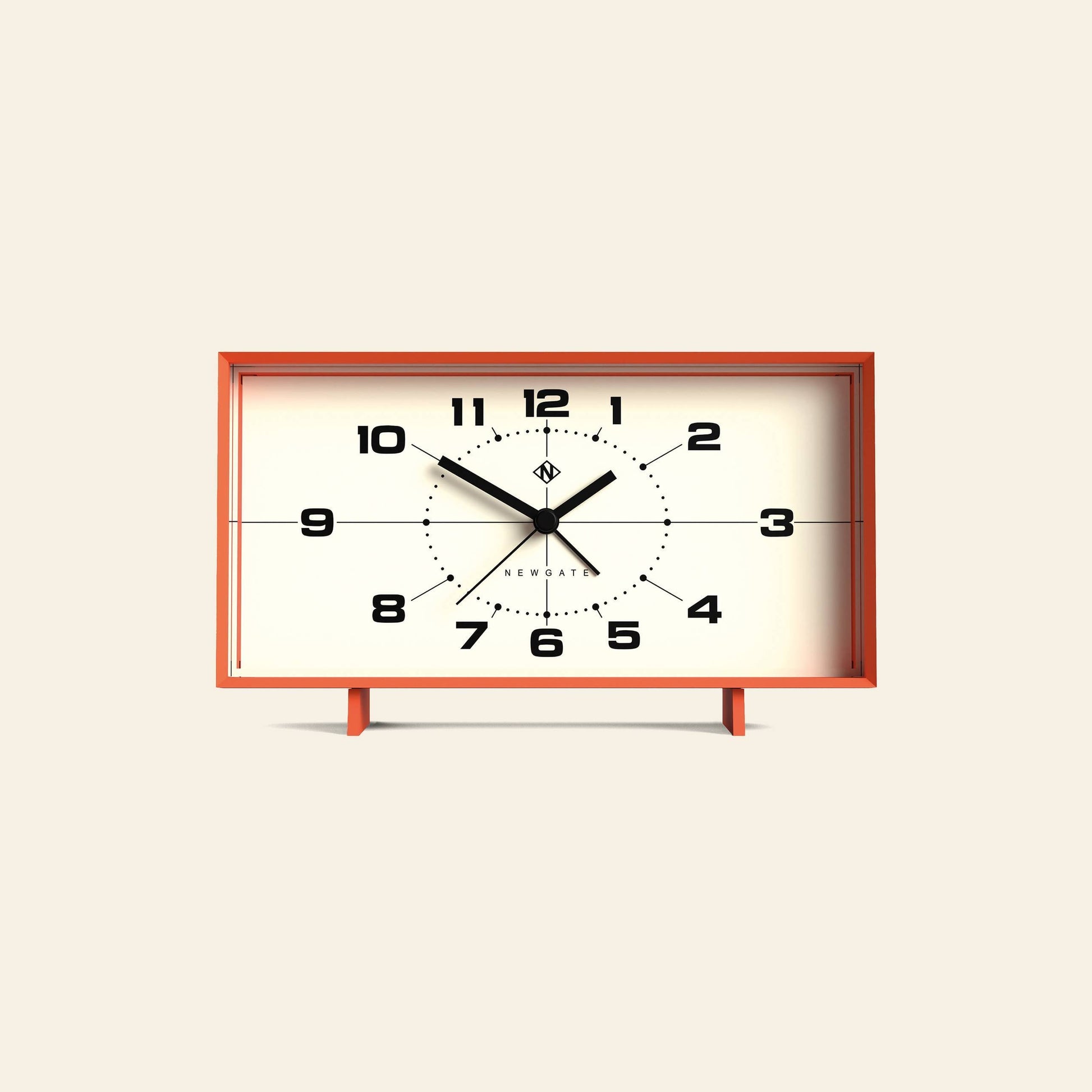 The Newgate Wideboy Alarm Clock by Newgate features a rectangular, retro design with a red-orange frame, black numbers, and stands on two small legs. The clock displays 10:09:36 against a beige background.