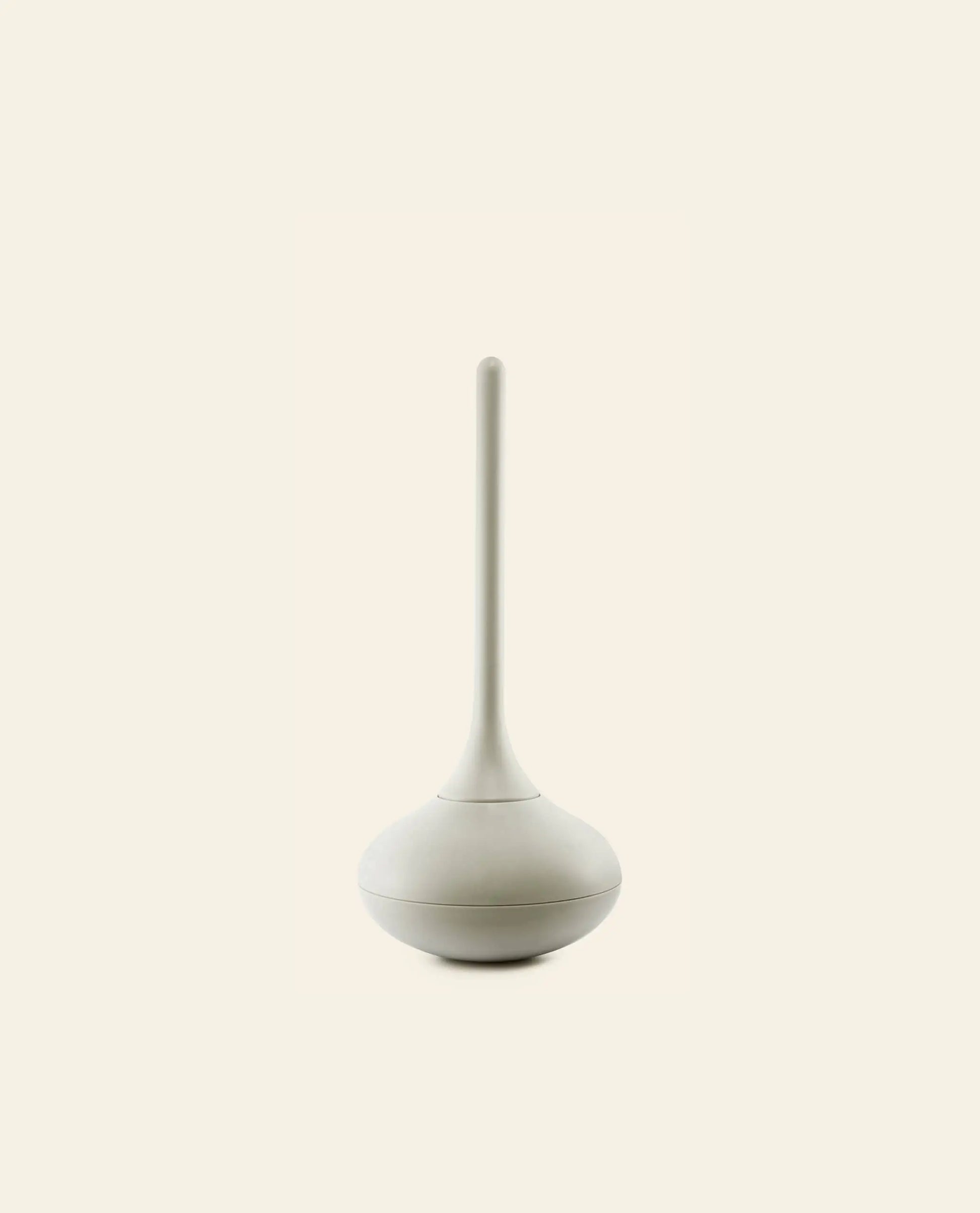 The Normann Copenhagen Ballo Toilet Brush features a minimalistic, modern white design with a rounded base and long handle, ideal for stylish bathroom cleaning. Set against a light beige background, its perfect for contemporary spaces.