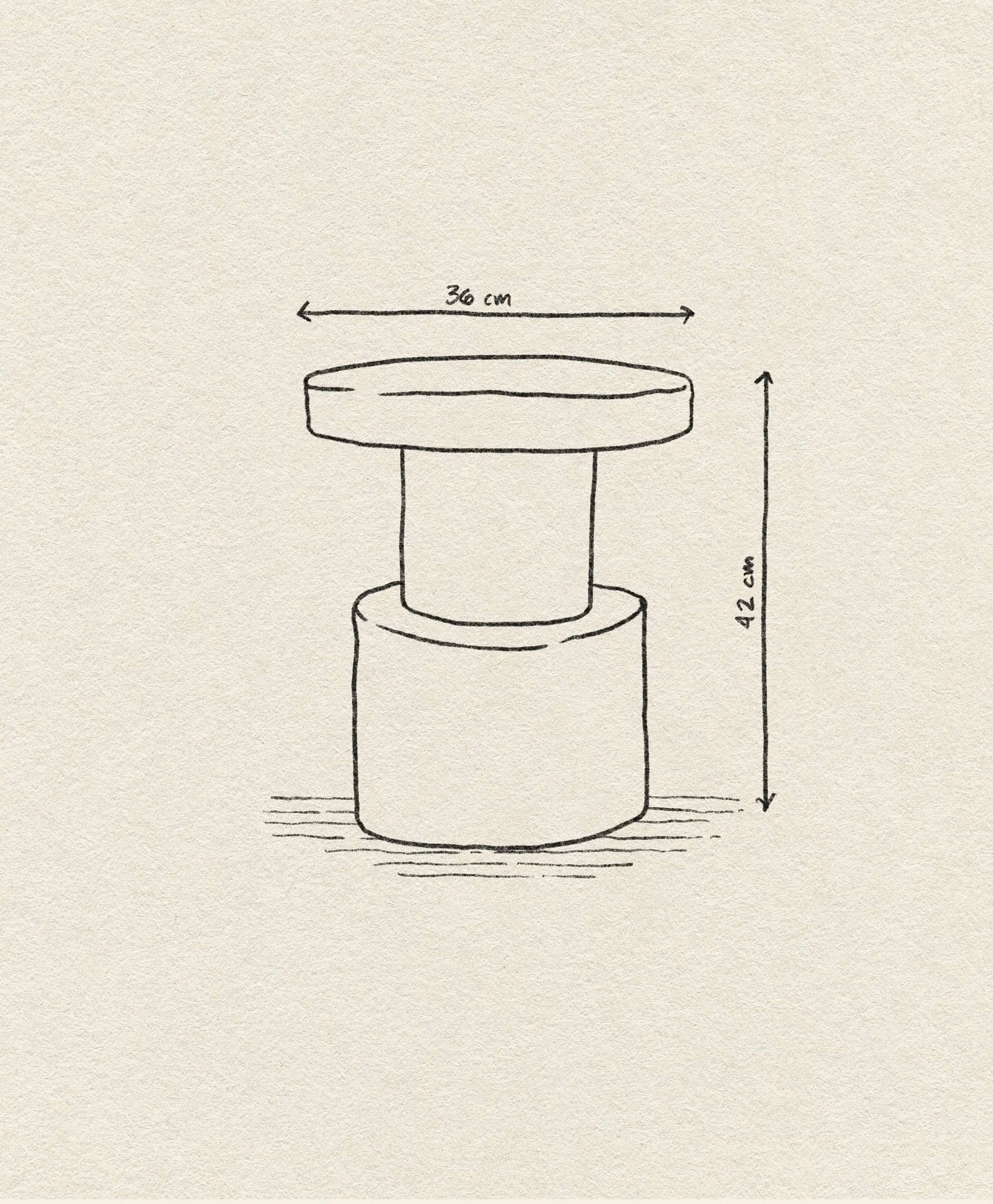 A simple line drawing of the Normann Copenhagen Bit Stool with a round top, labeled 36 cm diameter and 42 cm height. The image, on textured paper, highlights its multifunctional design. Brand: Normann Copenhagen.