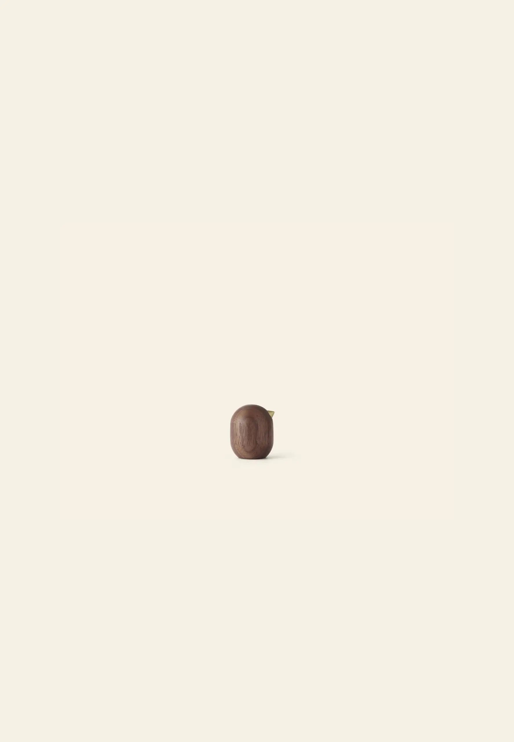 The Normann Copenhagen Little Bird, 4.5cm, by Normann Copenhagen is centered on a plain, light beige background with soft shadows for a minimalist design that makes a unique decor piece.