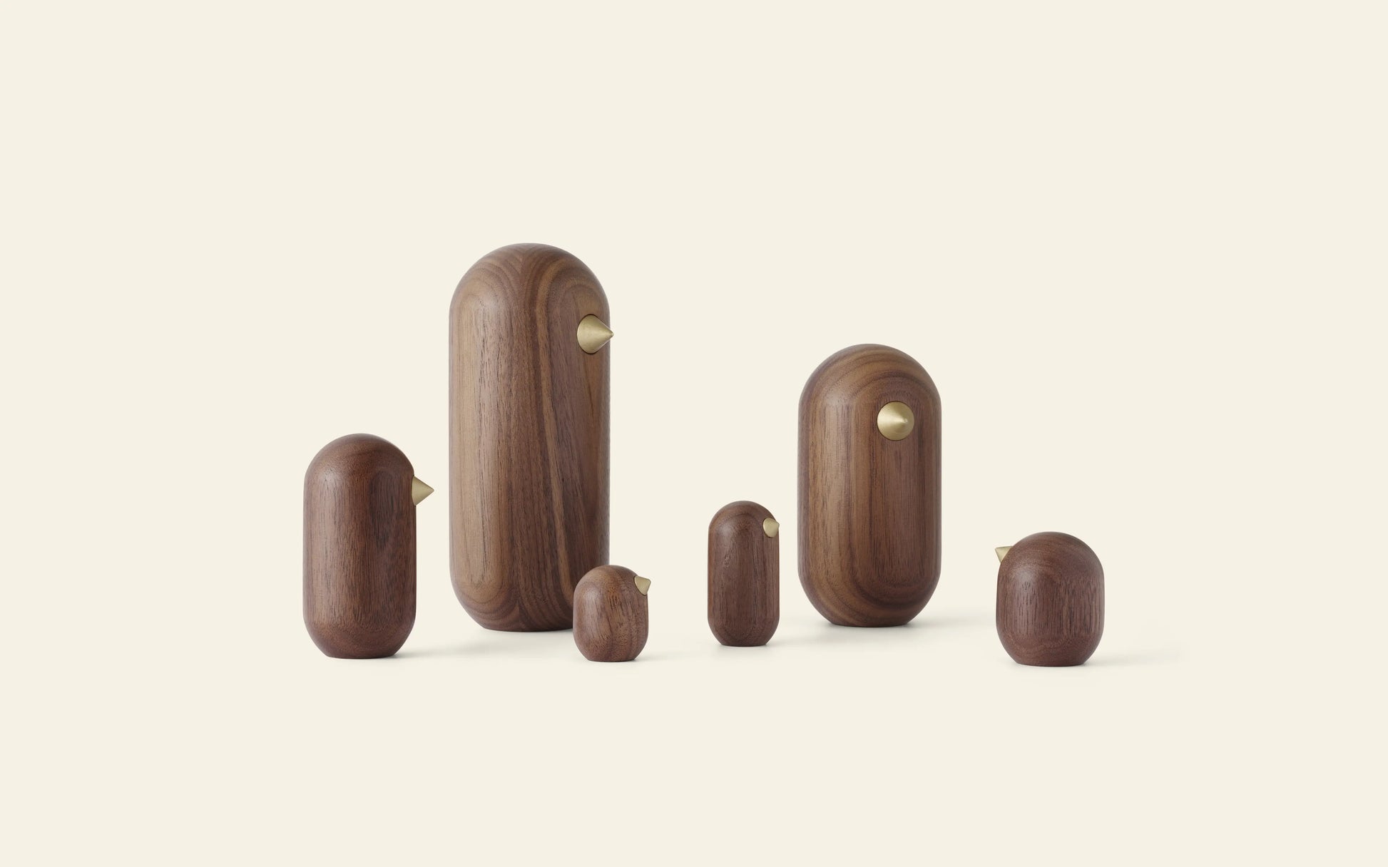 The Normann Copenhagen Little Bird, 7cm, by Normann Copenhagen is a minimalist wooden bird figurine with a brass beak—perfect for adding modern and timeless style to your home decor.