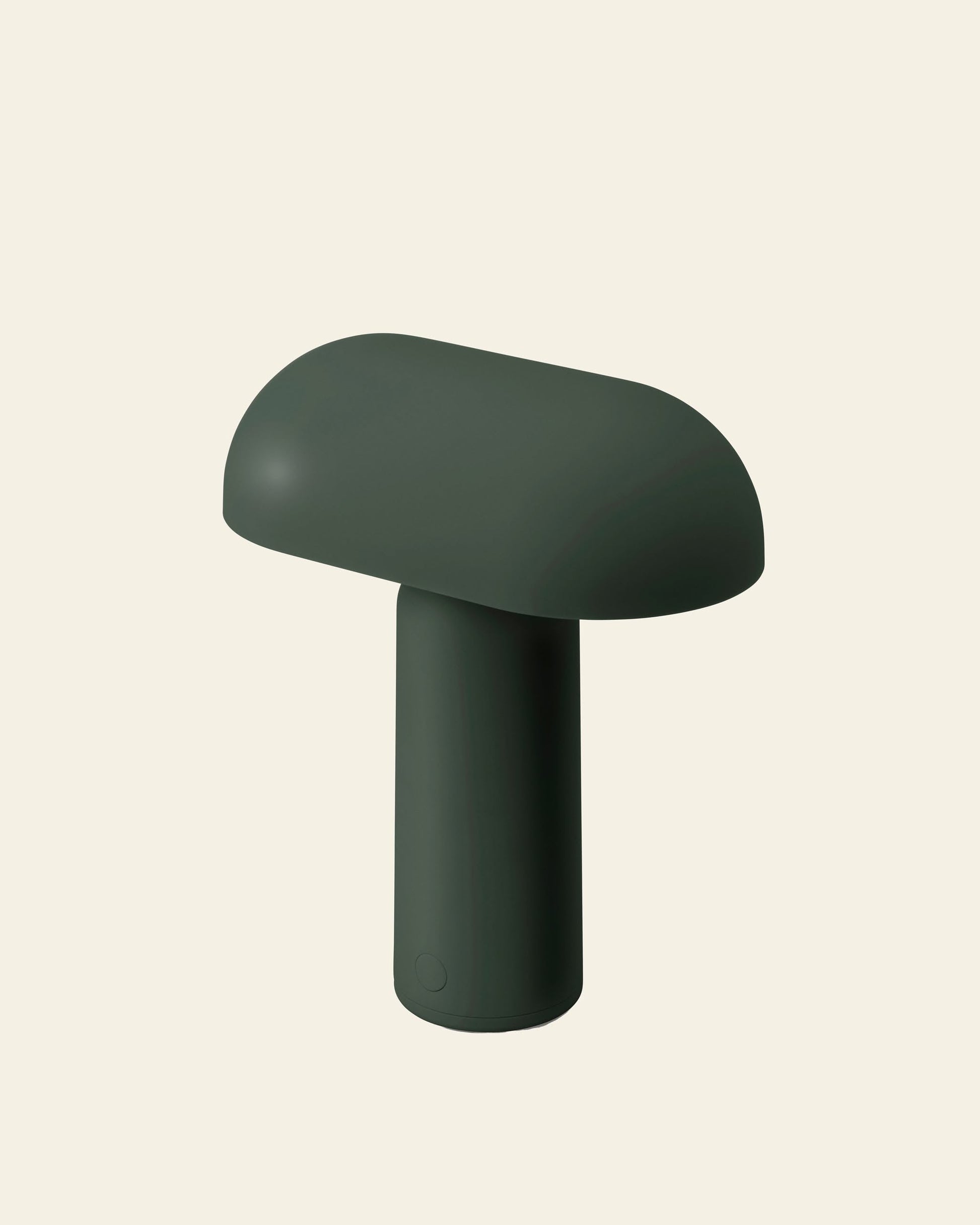 The Normann Copenhagen Porta Table Lamp by Normann Copenhagen features a dark green, mushroom-shaped design with a smooth, rounded top and cylindrical stem, shown against a plain light beige background.