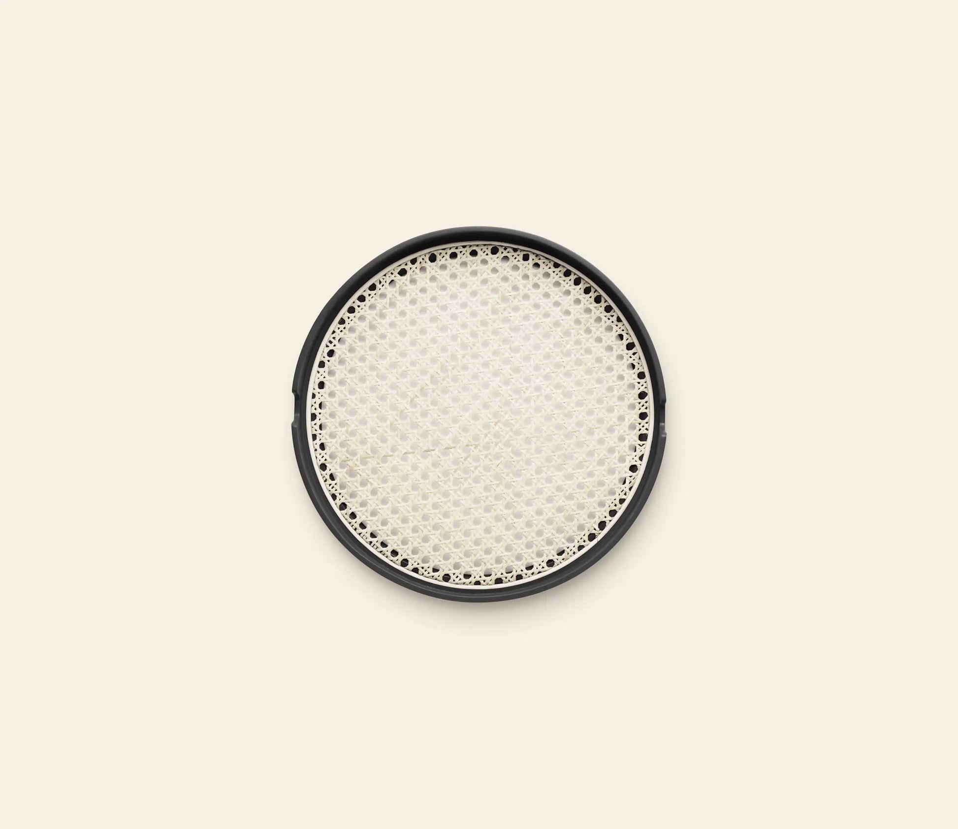 The Normann Copenhagen Salon Tray, 35cm, features a round black frame and a woven light-colored bamboo mesh center, shown against an off-white background.