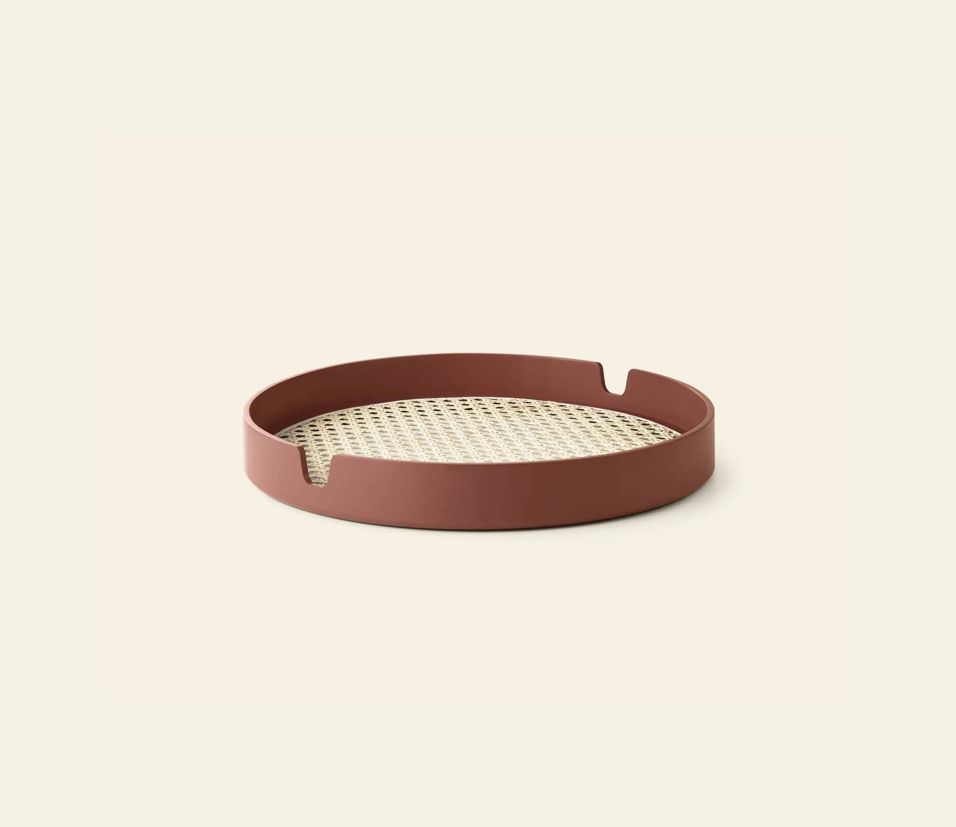 The Normann Copenhagen Salon Tray, 35cm, features a woven bamboo center and reddish-brown rim with two notched handles on opposite sides, shown against a plain light background.