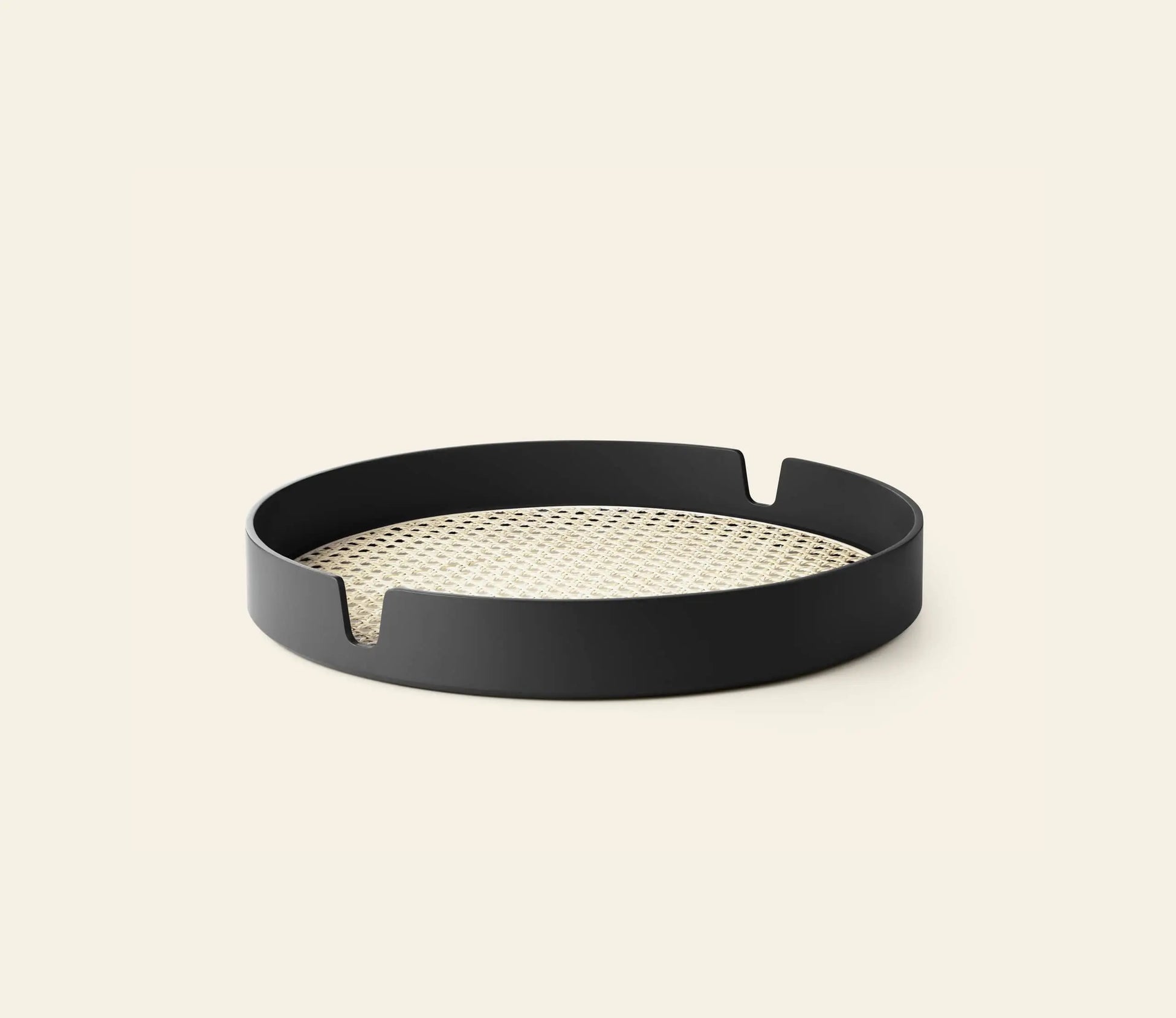 The Normann Copenhagen Salon Tray, 40cm, features a black high-sided rim, woven rattan base, and two curved slots on opposite sides—combining style and function from Normann Copenhagen.