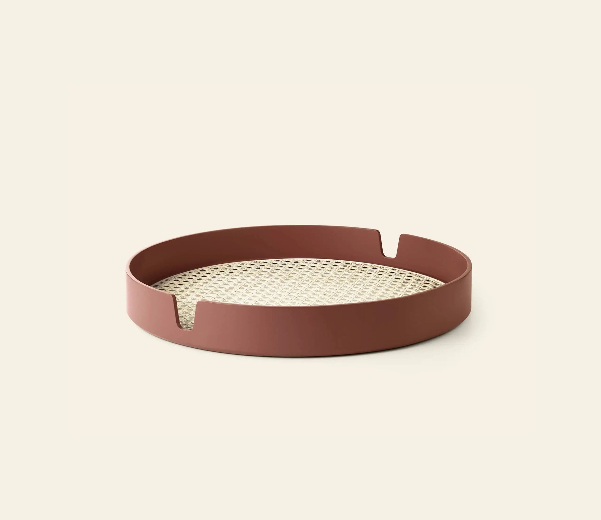 The Normann Copenhagen Salon Tray, 40cm, features a round bamboo design with a reddish-brown rim, notched details, and a woven beige base—a stylish serving piece for any setting.