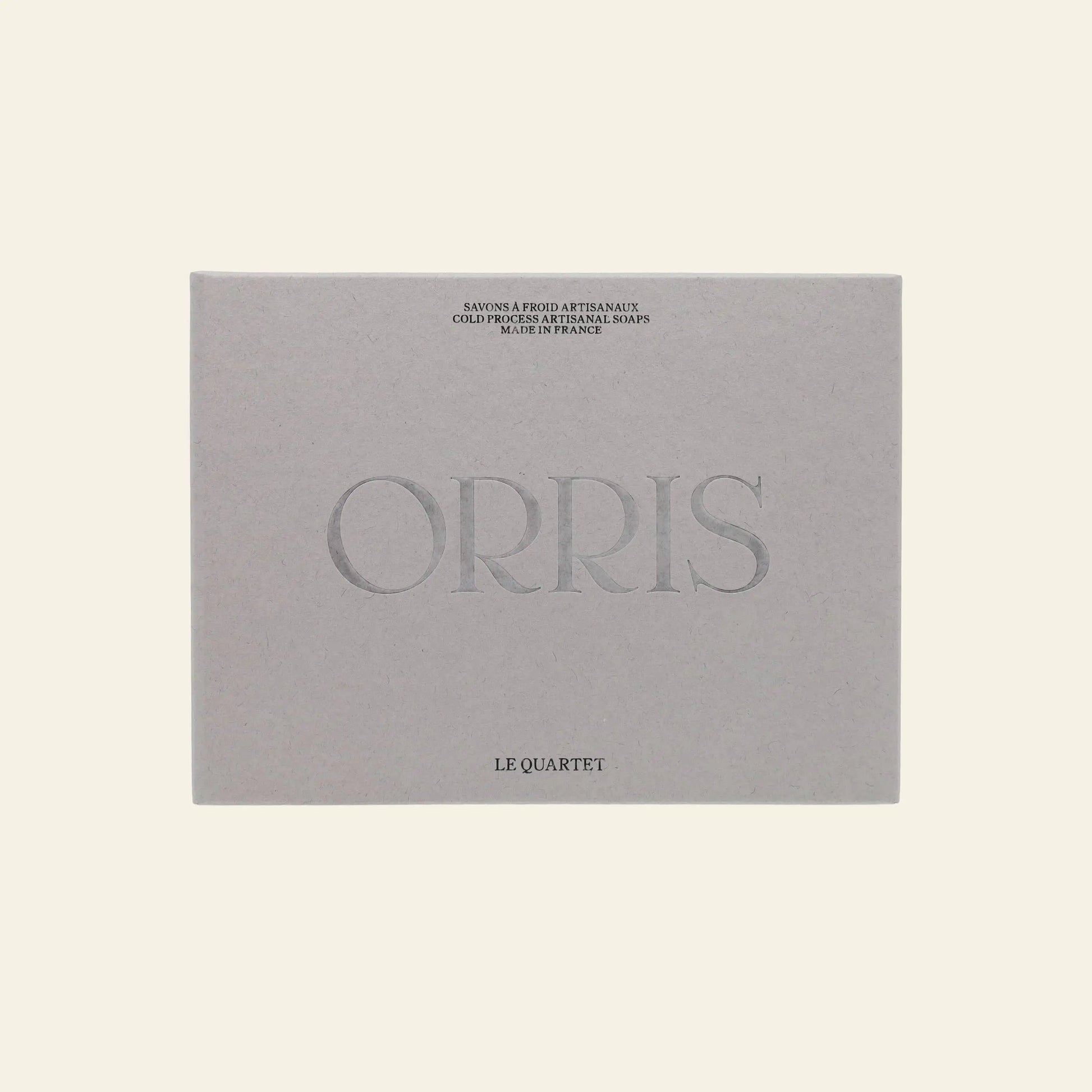 A beige ORRIS Le Quartet box features the brand name ORRIS prominently and contains botanical soap face and body cleansing bars, set against a light background.