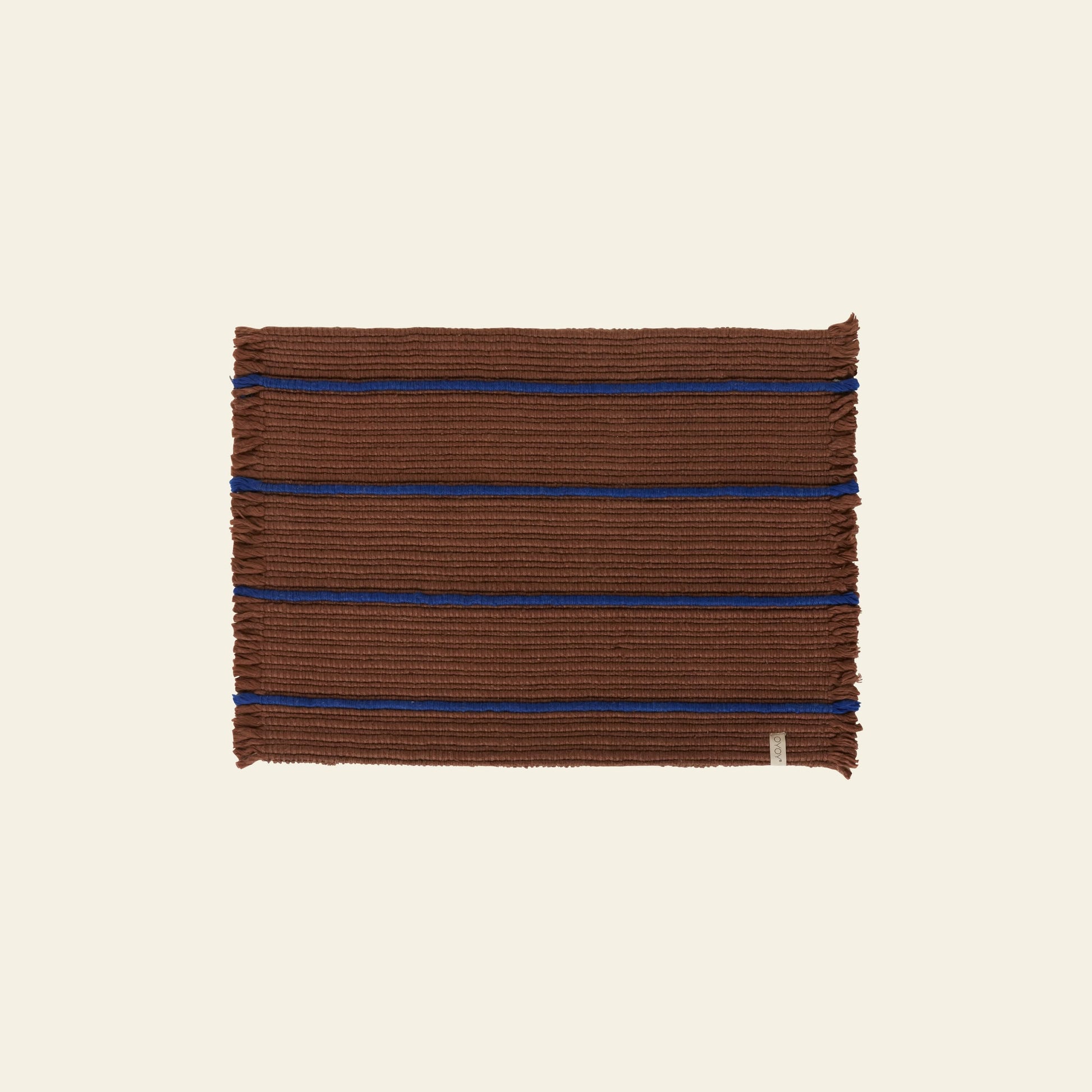 The OYOY Living Design Putki Recycled Doormat by OYOY Living Design features a rectangular brown woven design with blue stripes and ribbed detailing, made from recycled materials for sustainability, shown on a light beige background.