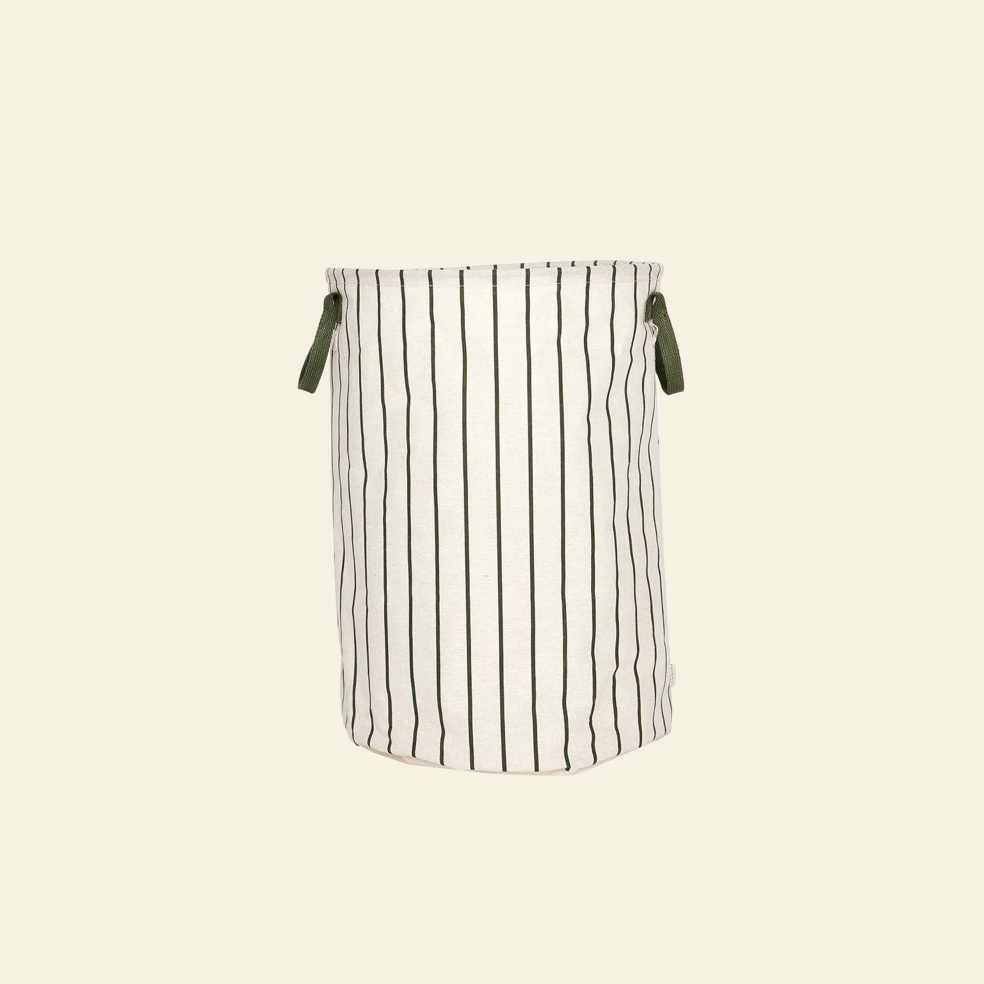 The OYOY Living Design Raita Laundry & Storage Basket (Medium) features a cylindrical shape in white fabric, elegant vertical black stripes, and two green handles, displayed against a plain beige background.