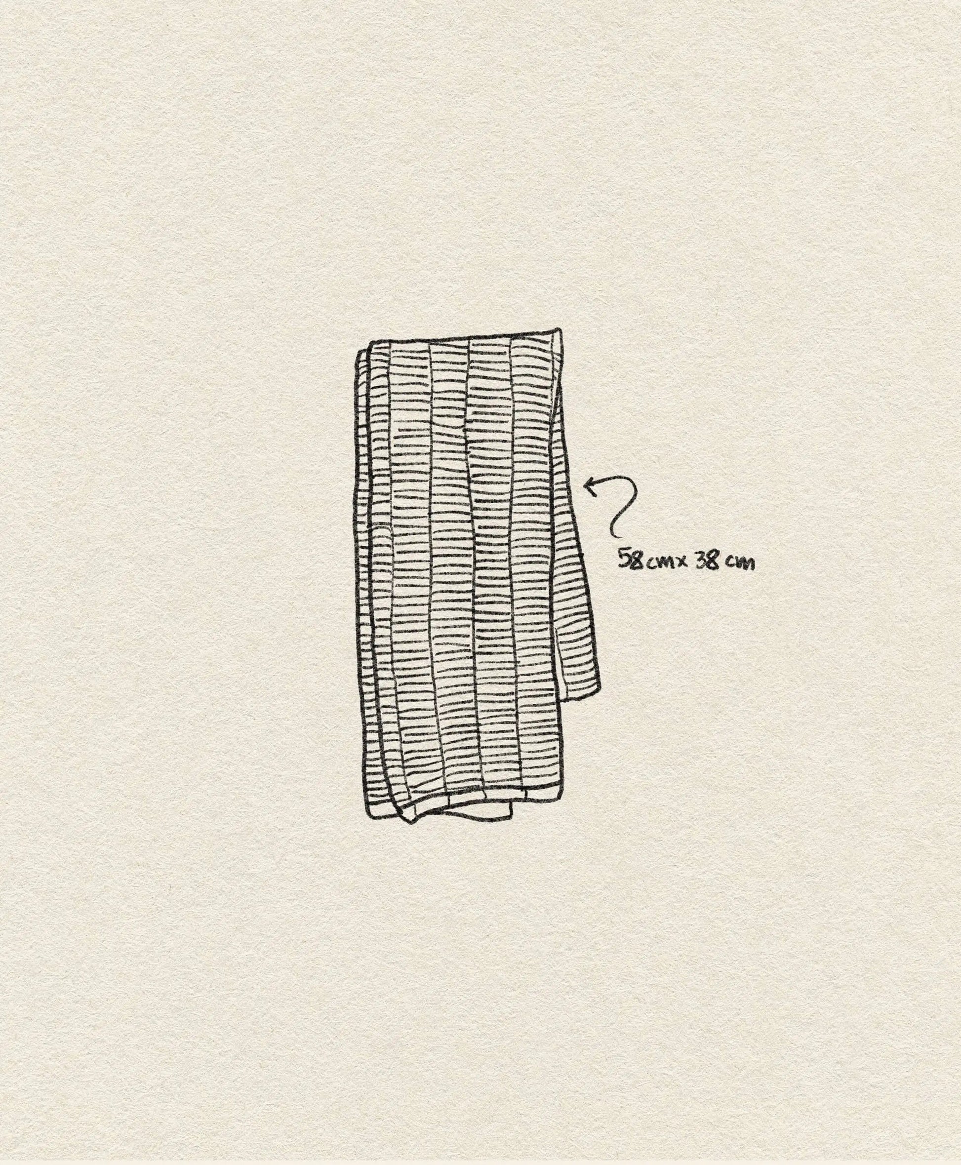 A hand-drawn illustration shows the OYOY Living Design Stringa Mini Towel, a folded rectangular towel made from knitted organic cotton (58 x 38 cm) by OYOY Living Design. The off-white textured background suggests luxury.