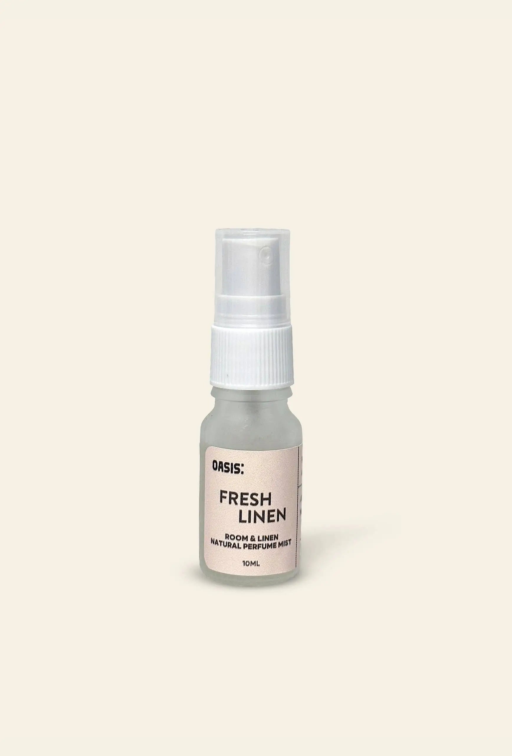 A 10ml bottle of Oasis Beauty Kitchen Room and Linen Mist stands upright against a plain beige background, delivering a perfume-grade mist with fresh linen notes.
