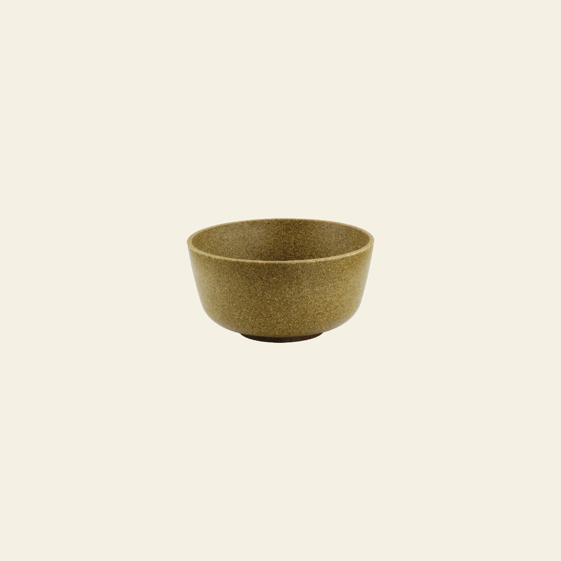 A small Pass It On Capsule Bowl, Rice Husk—a brown bowl made from upcycled rice husks—is centered on a plain, light beige background.