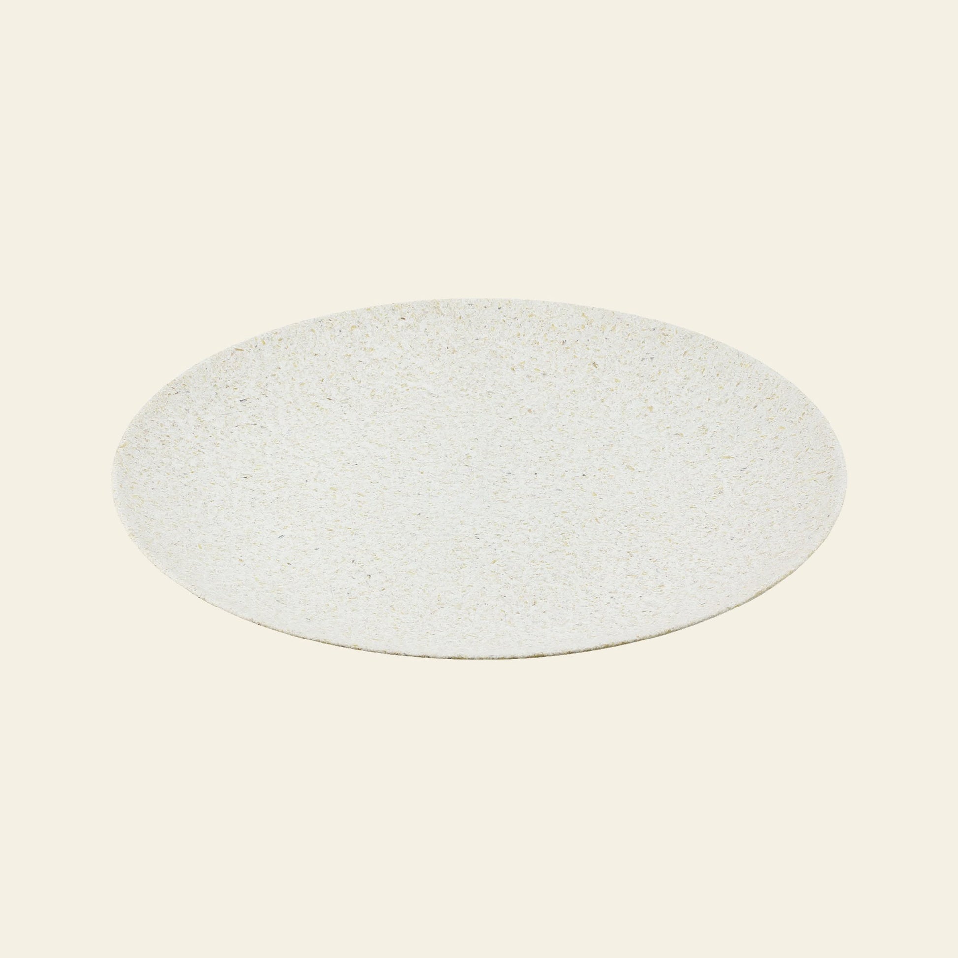 The Pass It On Dining Plate L, Rice Husk by Pass It On is a round, flat, light-speckled beige plate made from upcycled rice husks, featuring a minimalist design and smooth texture—ideal for sustainable dining on an off-white backdrop.