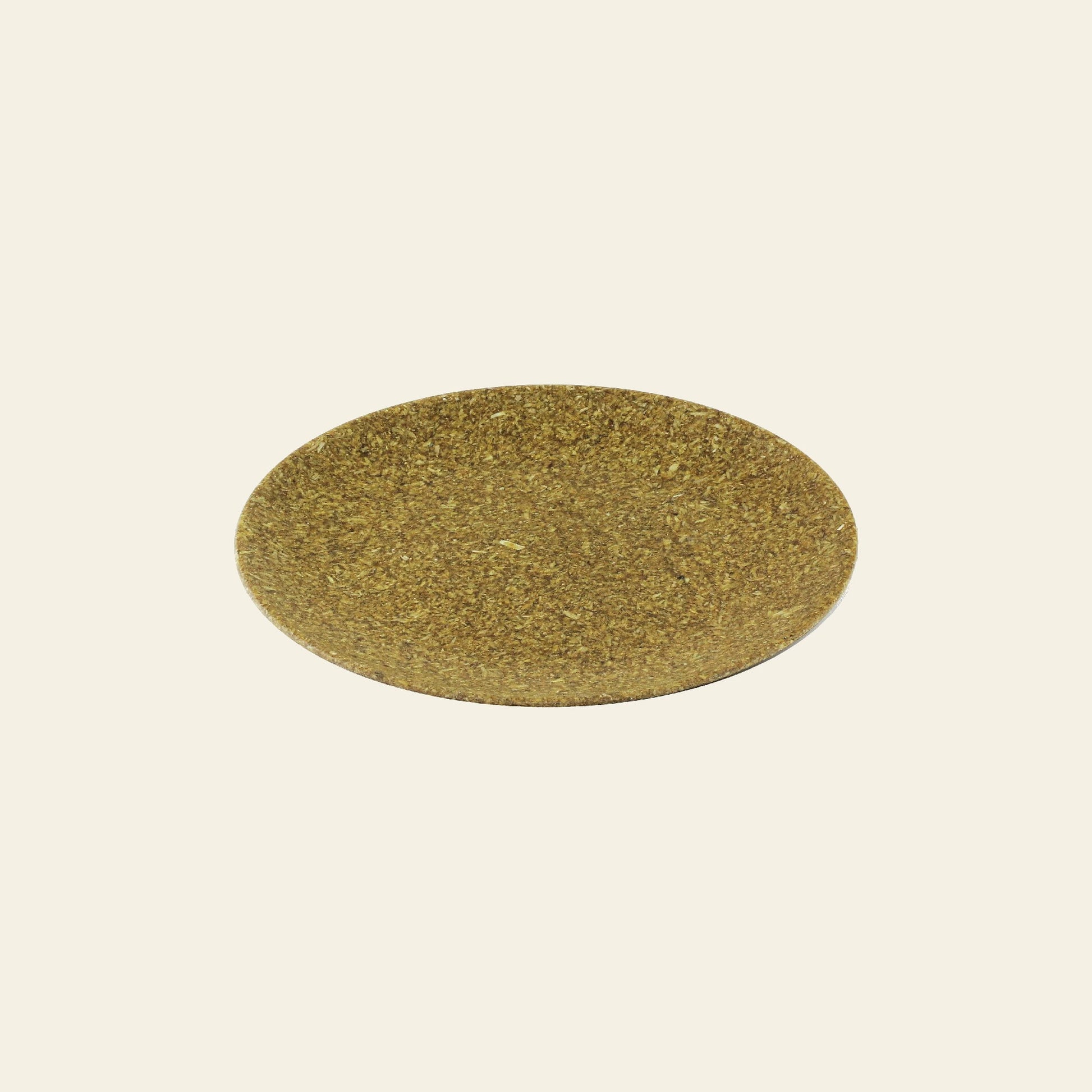 A round, flat, brownish-green Pass It On Dining Plate M, made from rice husk by Pass It On, is centered on a plain off-white background.