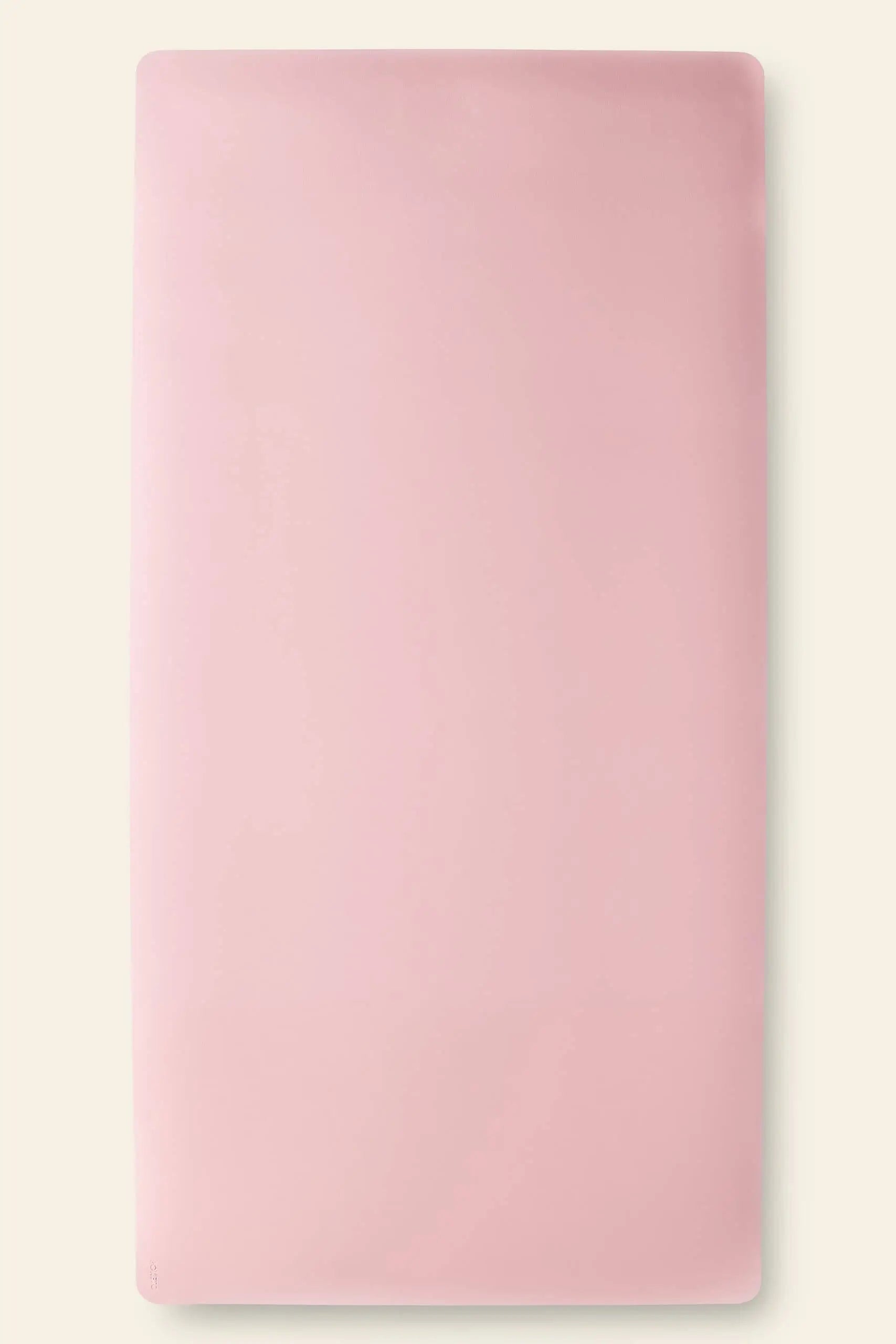 The Poketo Minimalist Mat by Poketo is a rectangular, light pink yoga mat with a unique design and rounded corners, laid flat on a light surface for modern style during your practice.