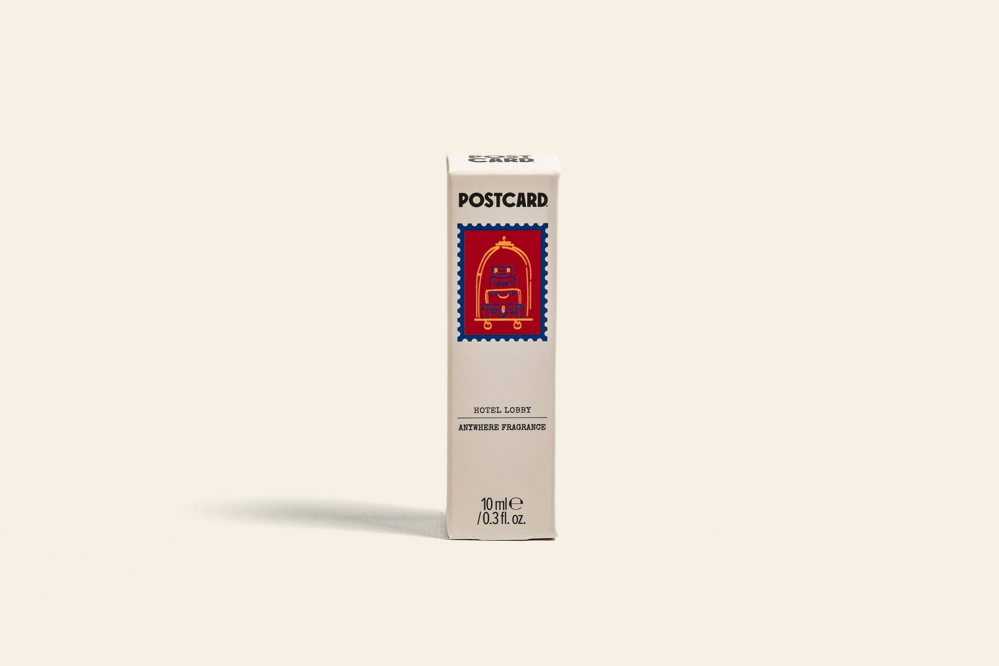 The Postcard Anywhere Fragrance, 10ml – Hotel Lobby, by Postcard, features a clean rectangular box with a red British-style mailbox illustration, capturing minimalist hotel luxury against a neutral background.