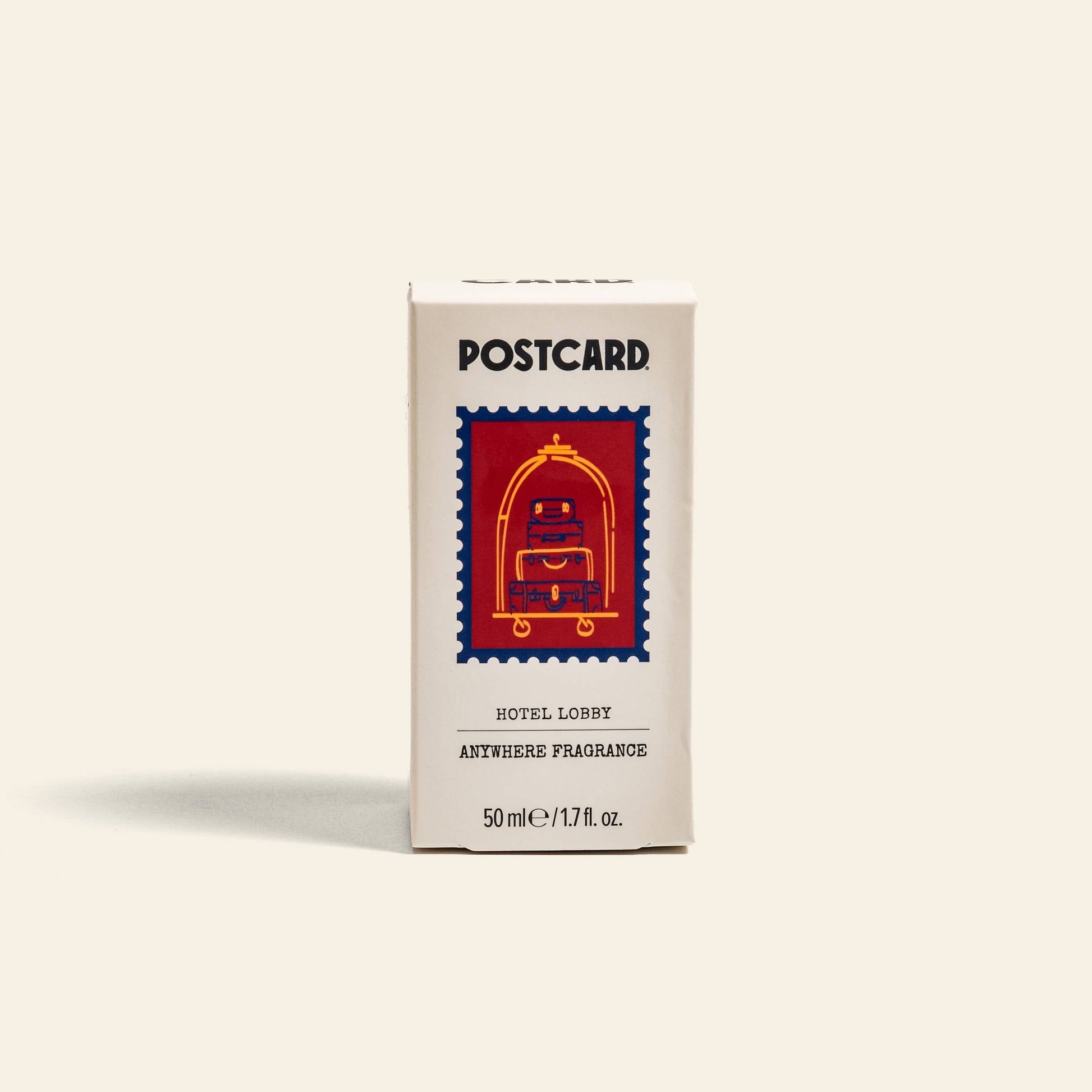 A white box labeled Postcard Anywhere Fragrance, 50ml - Hotel Lobby by Postcard features a bellhop cart with luggage and reads HOTEL LOBBY ANYWHERE FRAGRANCE. The scent evokes hotel luxury in a versatile 50 ml/1.7 fl. oz. spray.