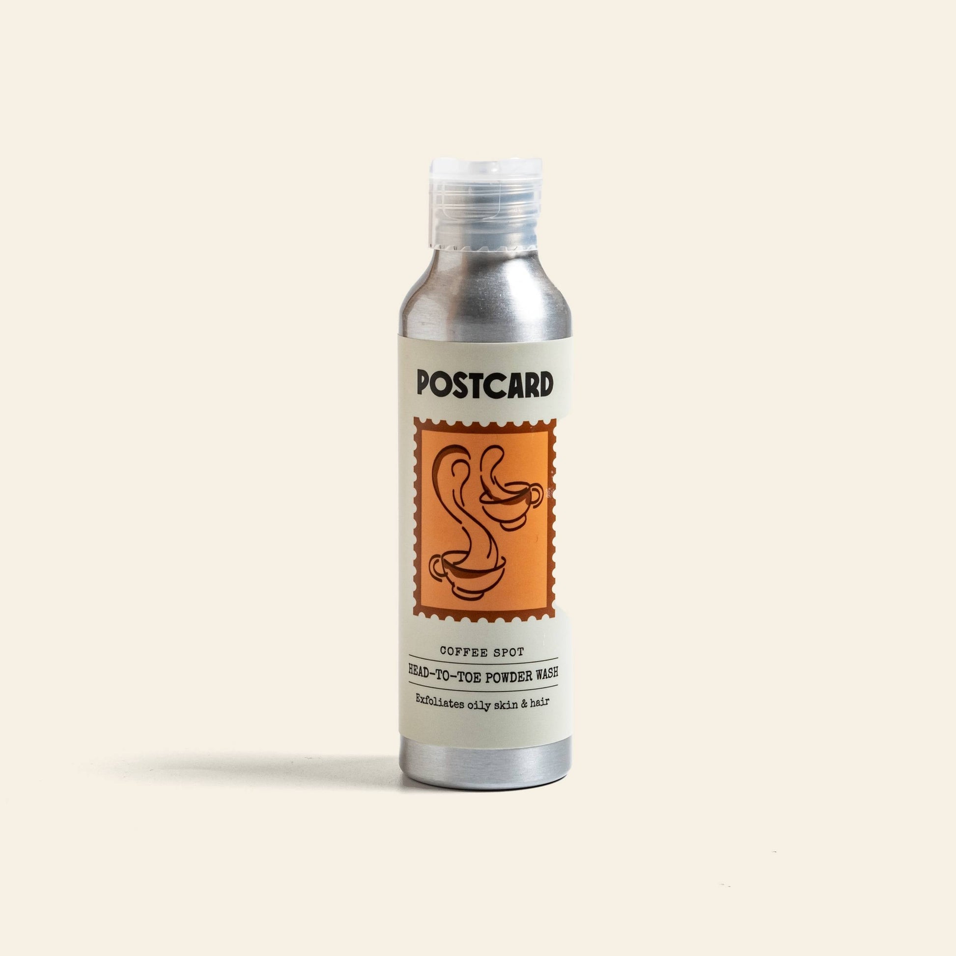 Postcard Head-To-Toe Powder Wash (80g) by Postcard comes in a silver bottle with an orange stamp and coffee cup. This powder-to-foam cleanser for oily skin and hair uses Javanese Arabica Coffee Oil.
