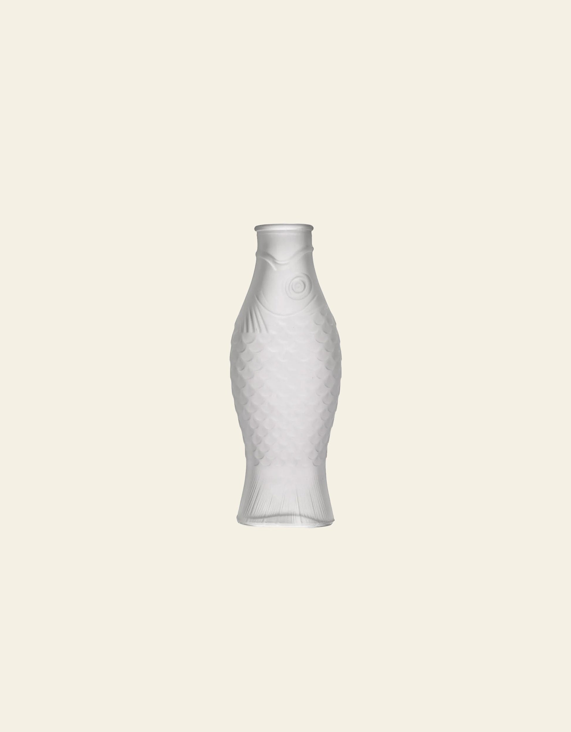 A frosted white Serax Fish & Fish Carafe by Serax, shaped like a fish, sits centered on a plain light beige background, making a stylish statement in unique tableware.