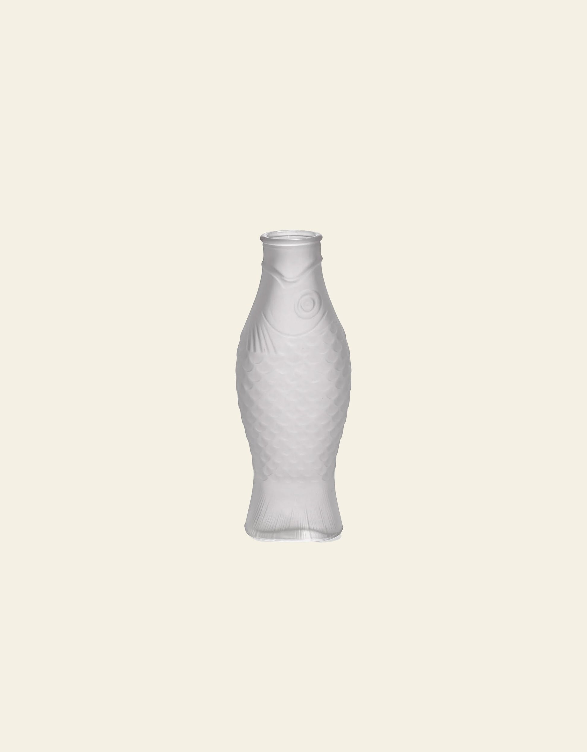 The Serax Fish & Fish Carafe by Serax, shaped like a fish, stands upright against a light beige background—an eye-catching piece ideal as unique tableware or a charming carafe for your table setting.