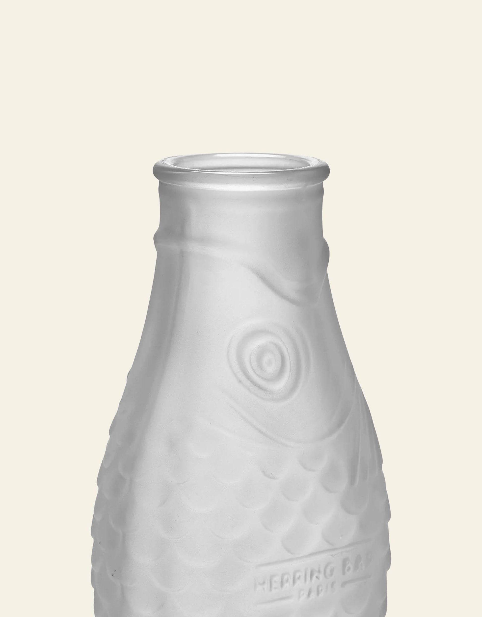 The Serax Fish & Fish Carafe by Serax features a frosted glass, fish-shaped design with textured scales, a prominent eye, and “HERRING BAR” embossed at the base—ideal for adding unique style to your tableware display. Photographed on a plain background.