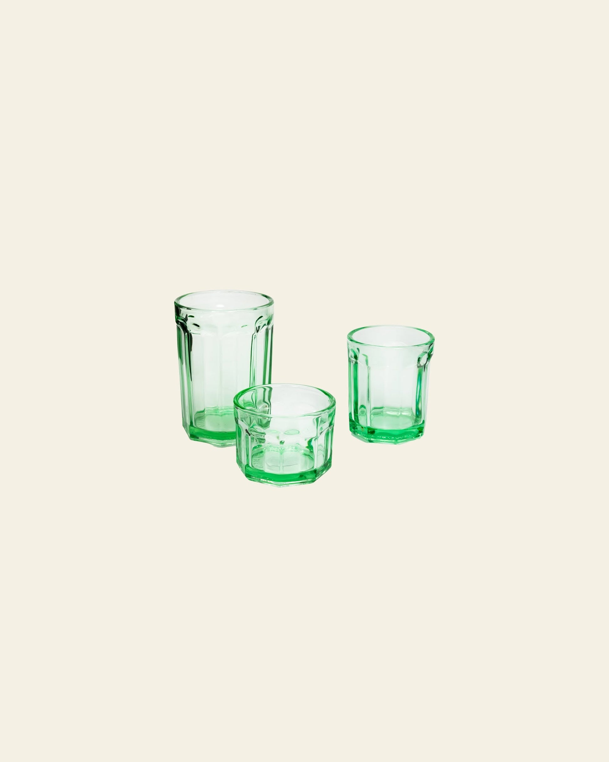 A trio of Serax Fish & Fish Glass M - Green tumblers from Serax are arranged on a light beige background.