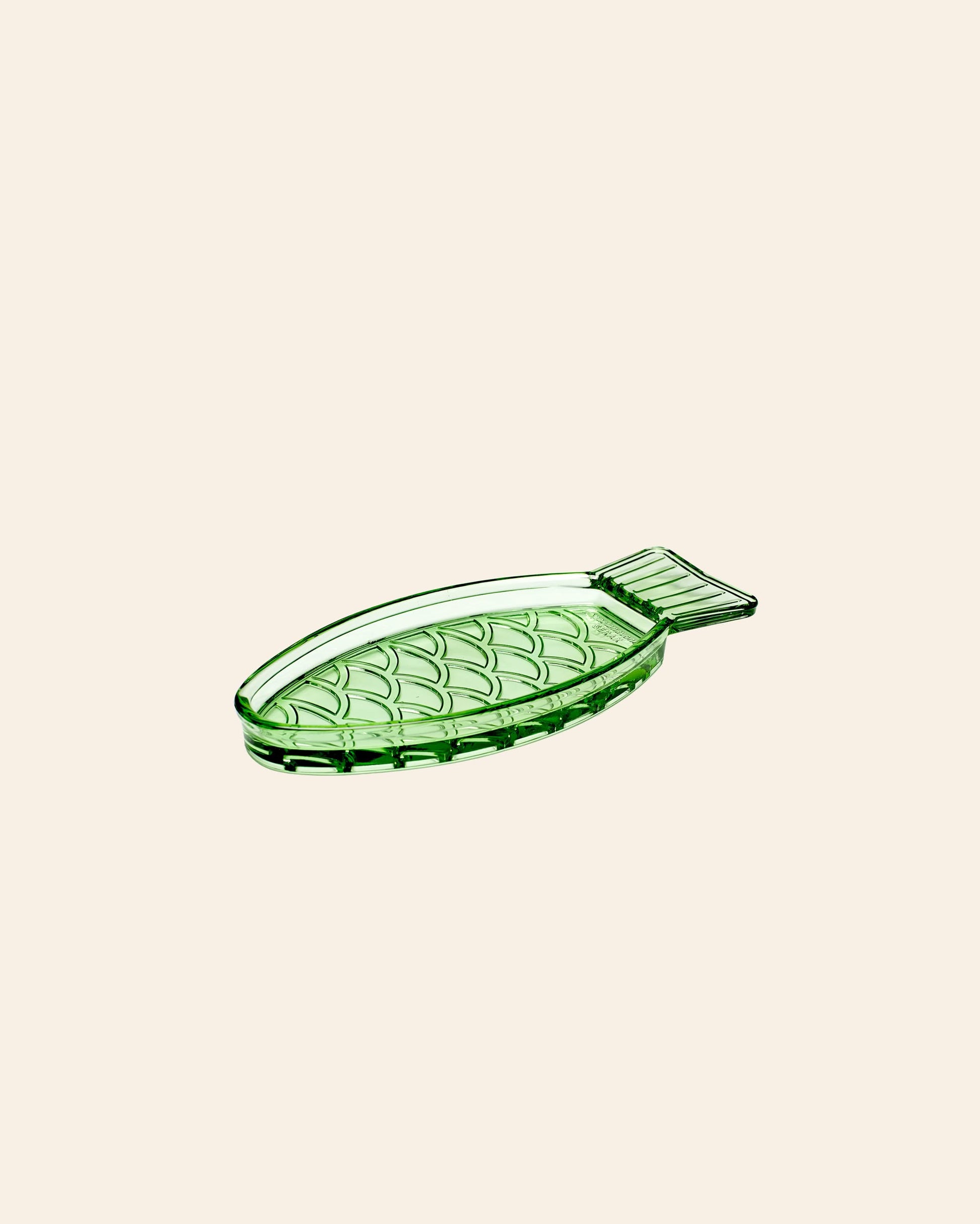 The Serax Fish & Fish Serving Dish N°1 - Green, a fish-shaped glass dish with scale and fin details by Serax, is shown on a plain beige background.