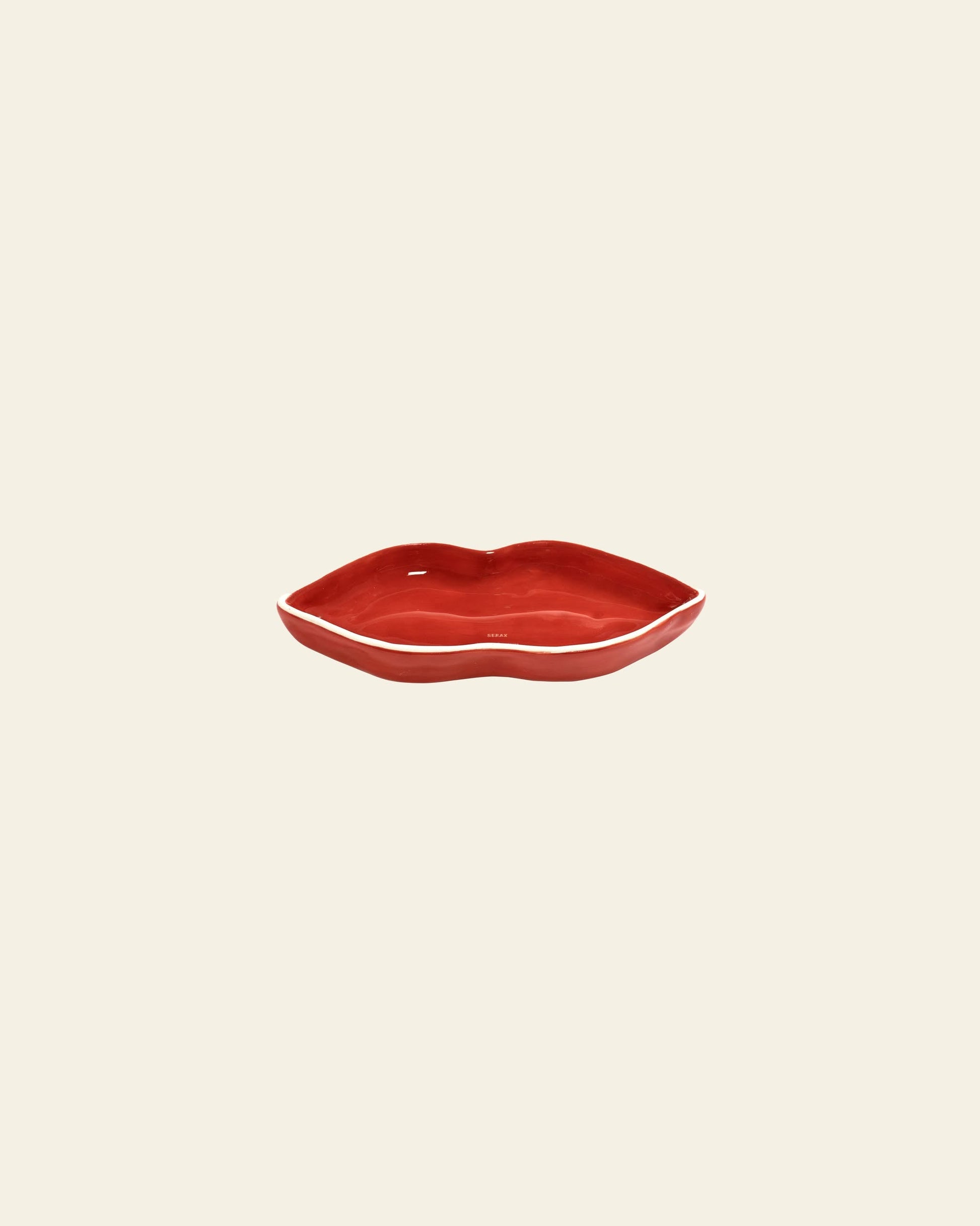 The Serax Les Objets Mouleversants Serving Dish S - Red, shaped like lips, is displayed centered on a plain beige background.