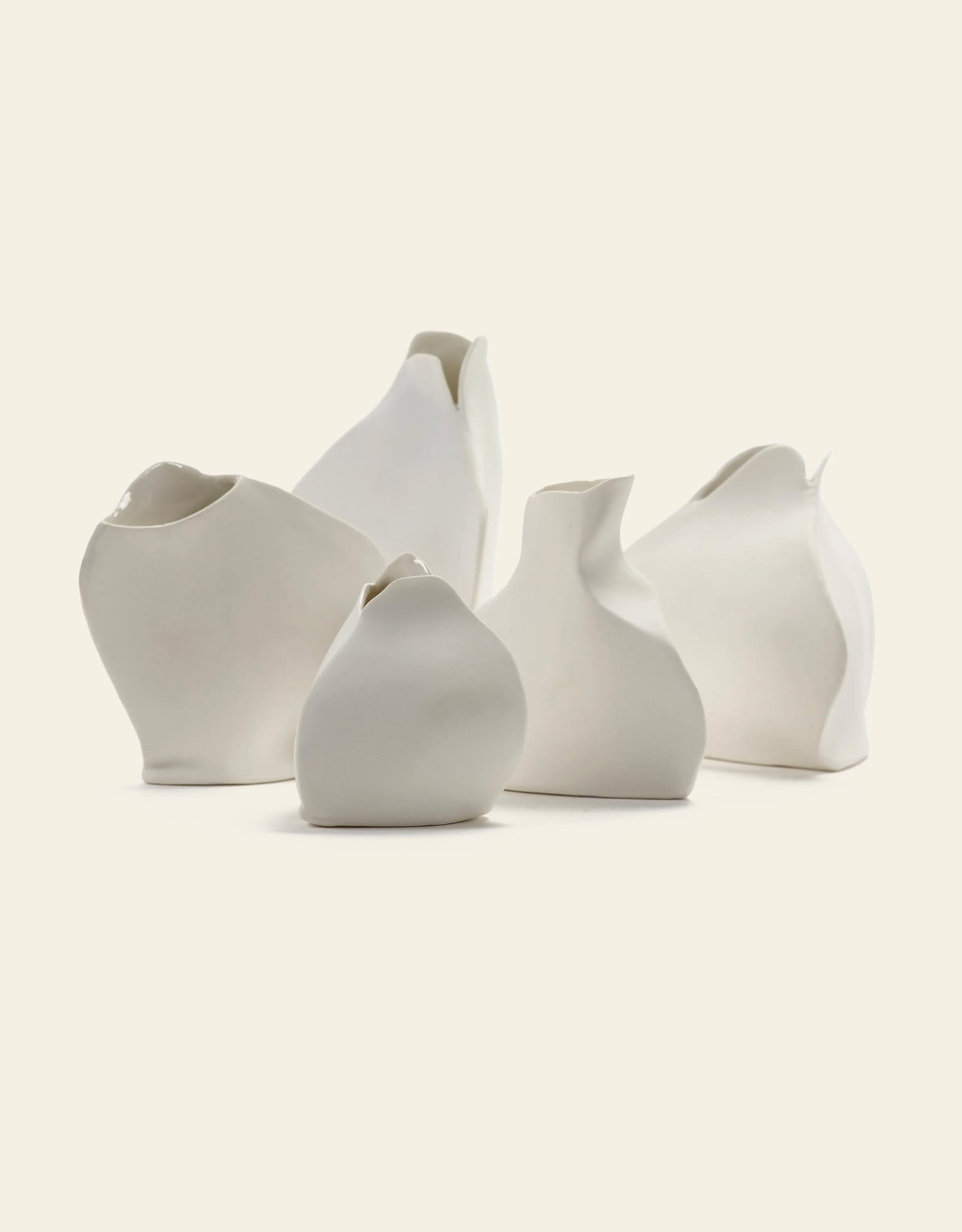 The Serax Perfect Imperfection Flower Vase N°5 in white by Serax is displayed on a light beige background, featuring an irregular, handcrafted shape and a smooth porcelain surface for a unique, organic look.