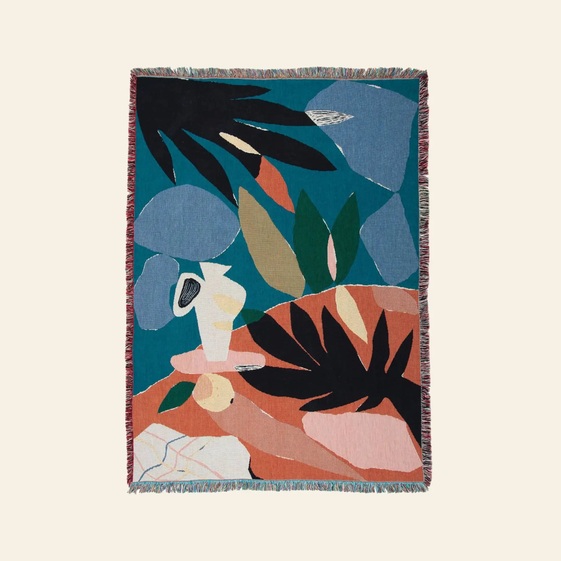 The Slowdown Studio Barbosa Throw by Slowdown Studio is a colorful woven blanket from recycled cotton, featuring abstract shapes in teal, blue, green, black, coral, and beige with fringe edges and a central white vase design.